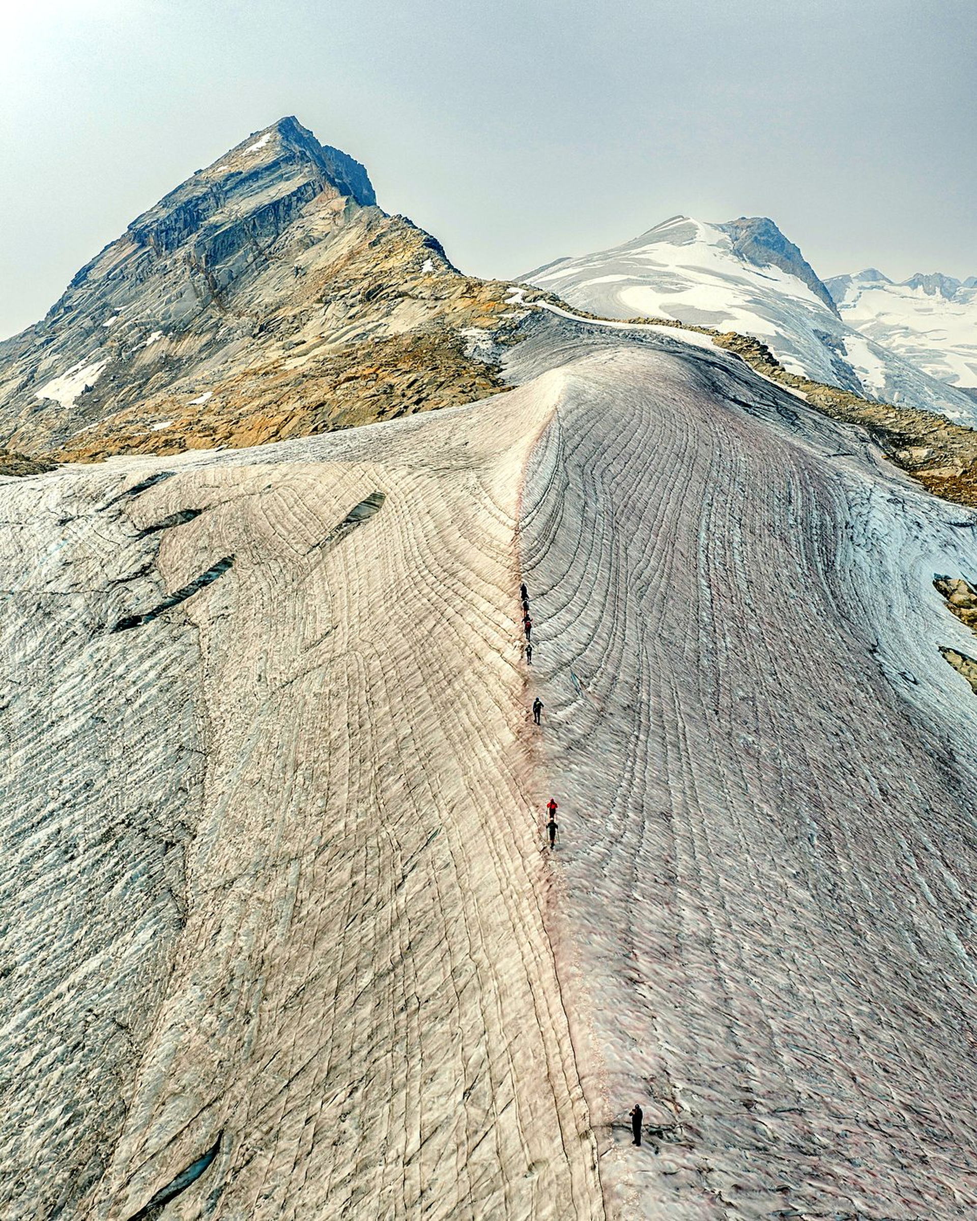 Hikers walking the Omoo Glacier near Battle Abbey