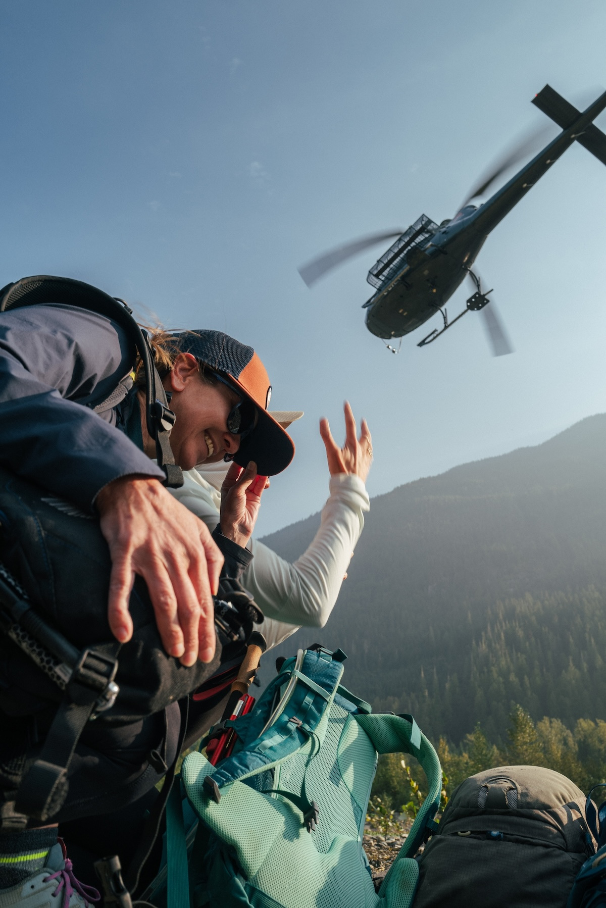 Crouched by the packs as the helicopter lifts away