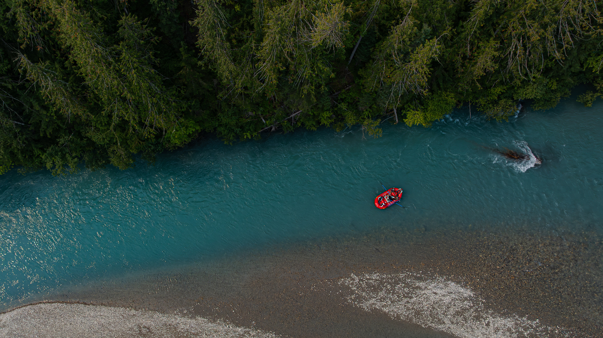 A raft on a glacier-fed river, seen from above