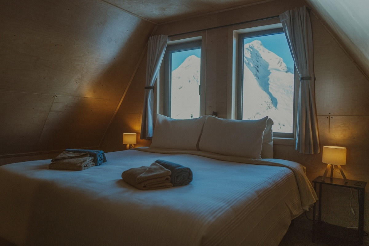 A guest room under the eaves, with the peaks in the window