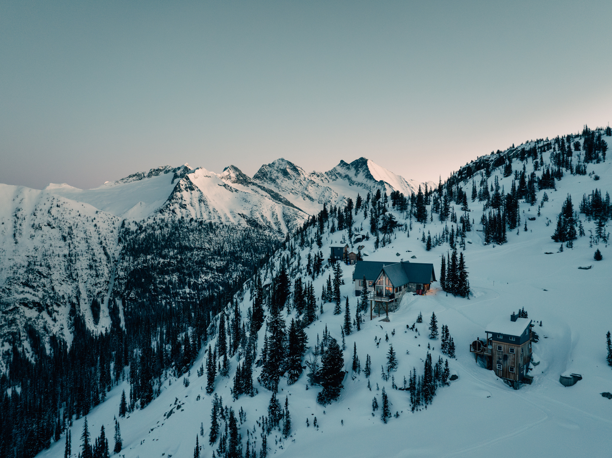 The lodge among the firs at first light