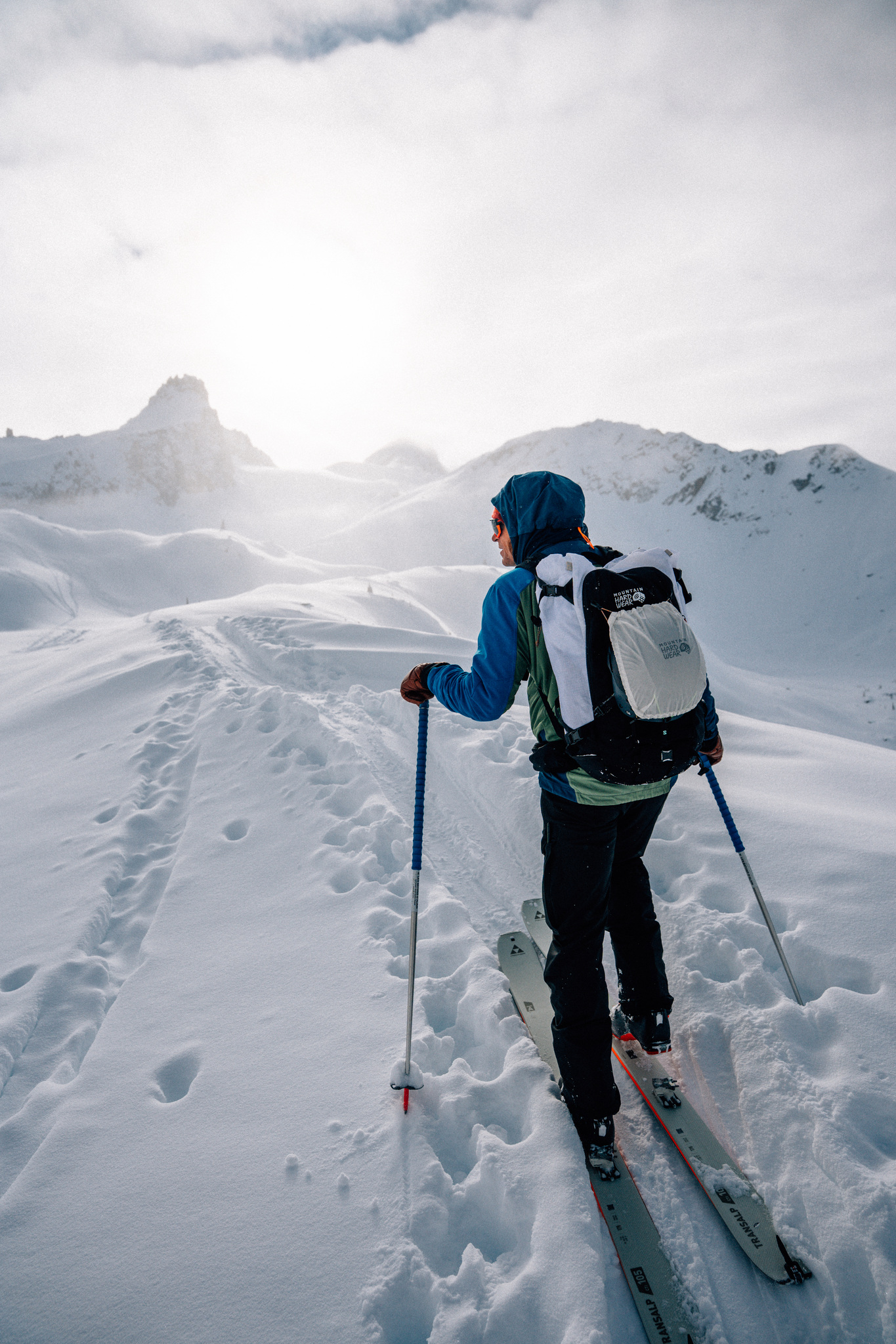 A ski tourer on the skin track, looking up at the next summit