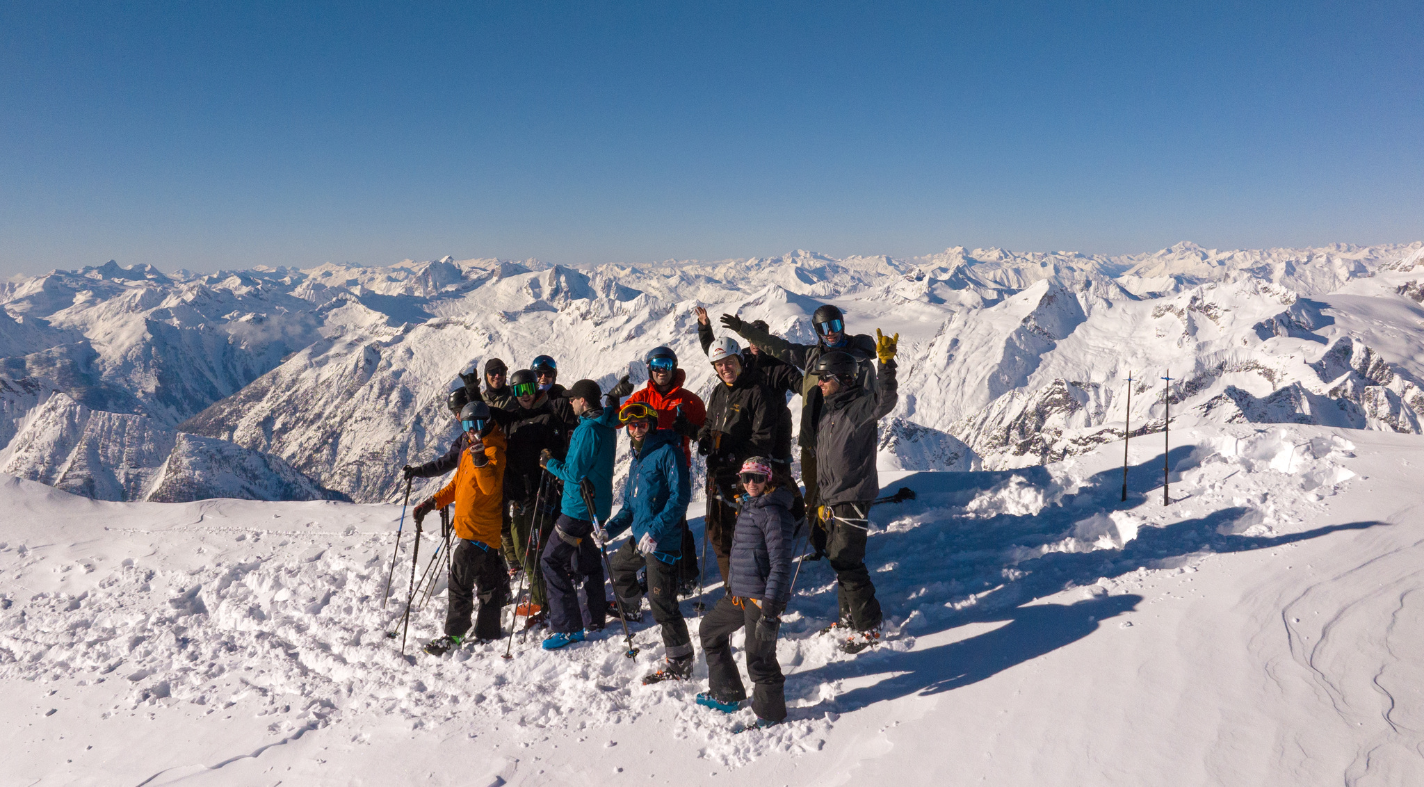 The whole group on a summit, with the range rolling away behind