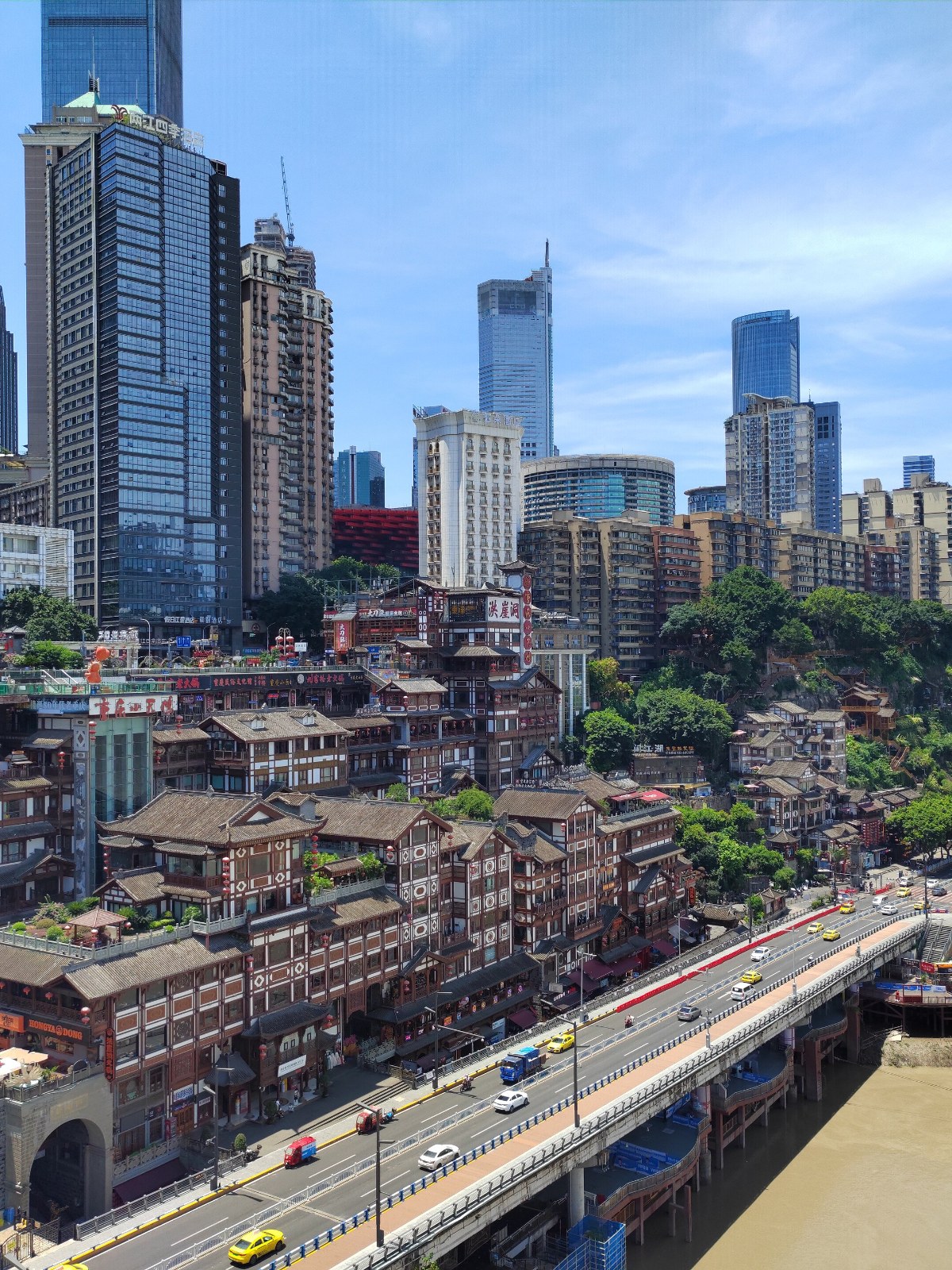 Hongyadong's stilted riverfront buildings beneath Chongqing's modern towers