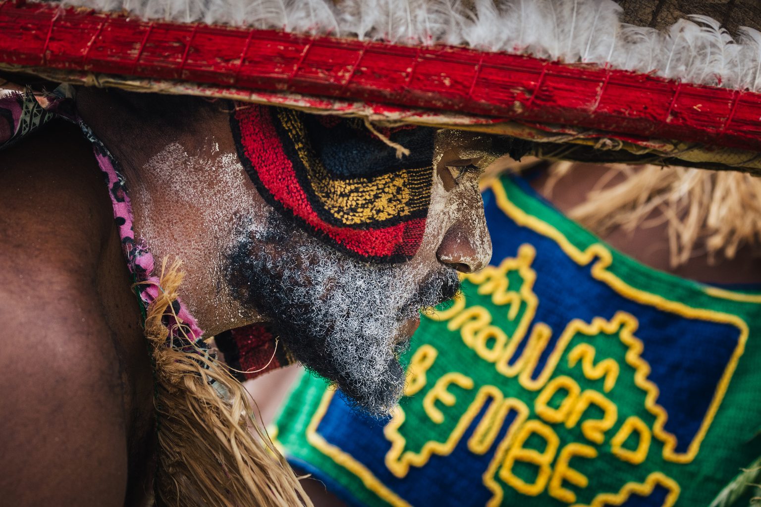 Close detail of a beaded headdress and painted face in the Papua New Guinea Highlands