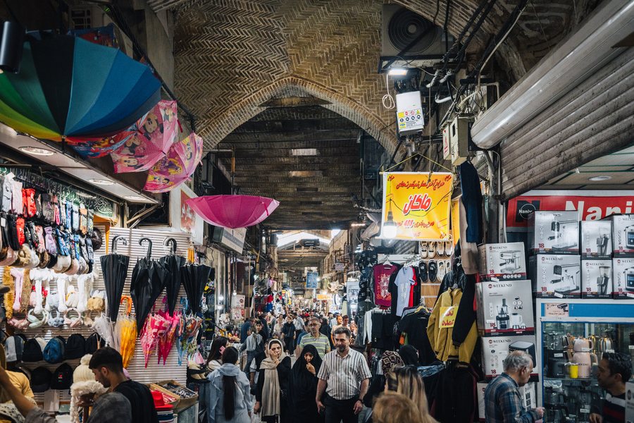 Shoppers under the vaulted brick arcades of the Grand Bazaar in Tehran