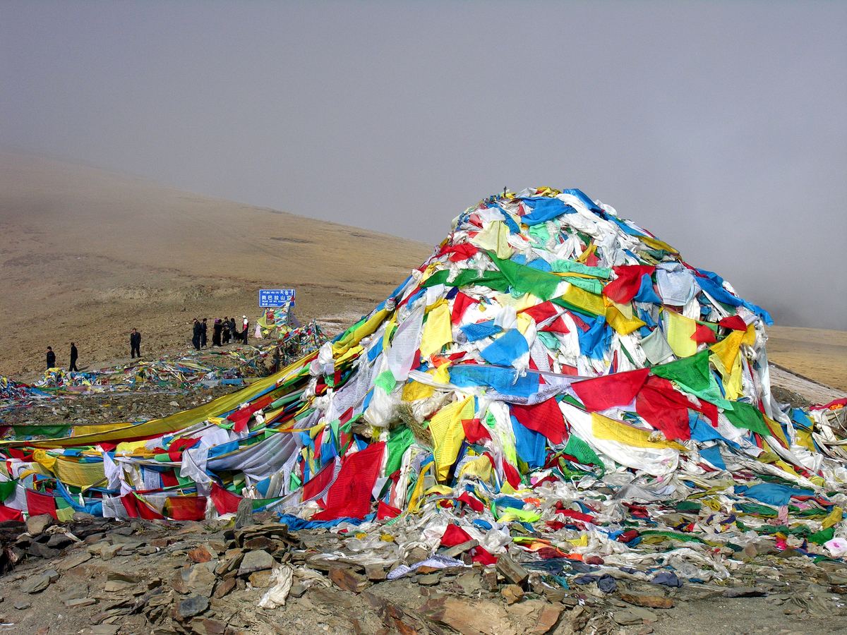 Prayer flags streaming over a high pass, Tibet