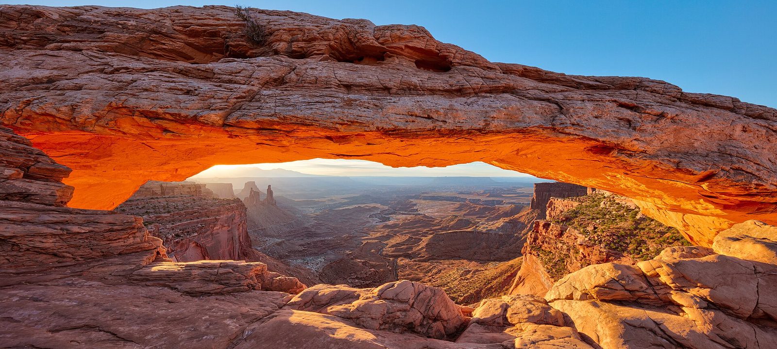 Sunrise glowing beneath Mesa Arch, Canyonlands National Park, Utah