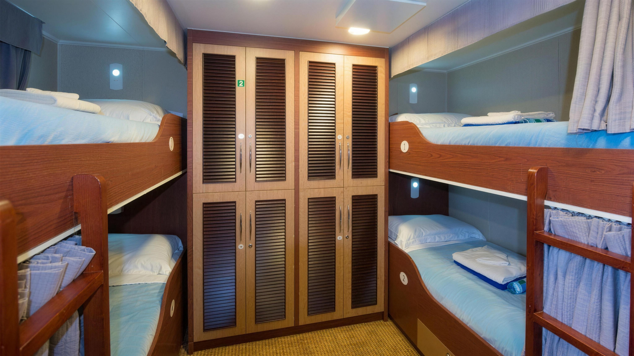A Class C dormitory, with bunks either side of a wardrobe