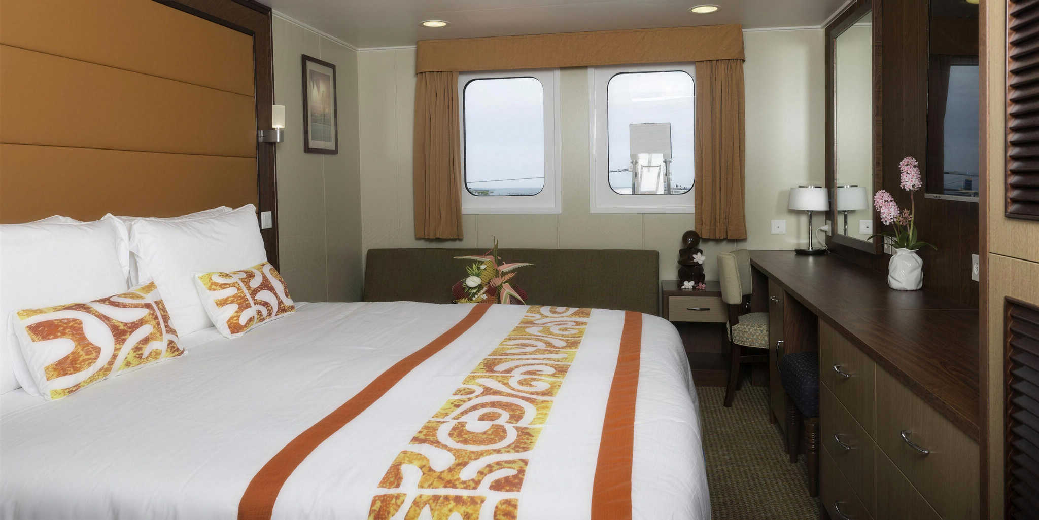 A Junior Suite without a balcony, with a king bed and two large windows
