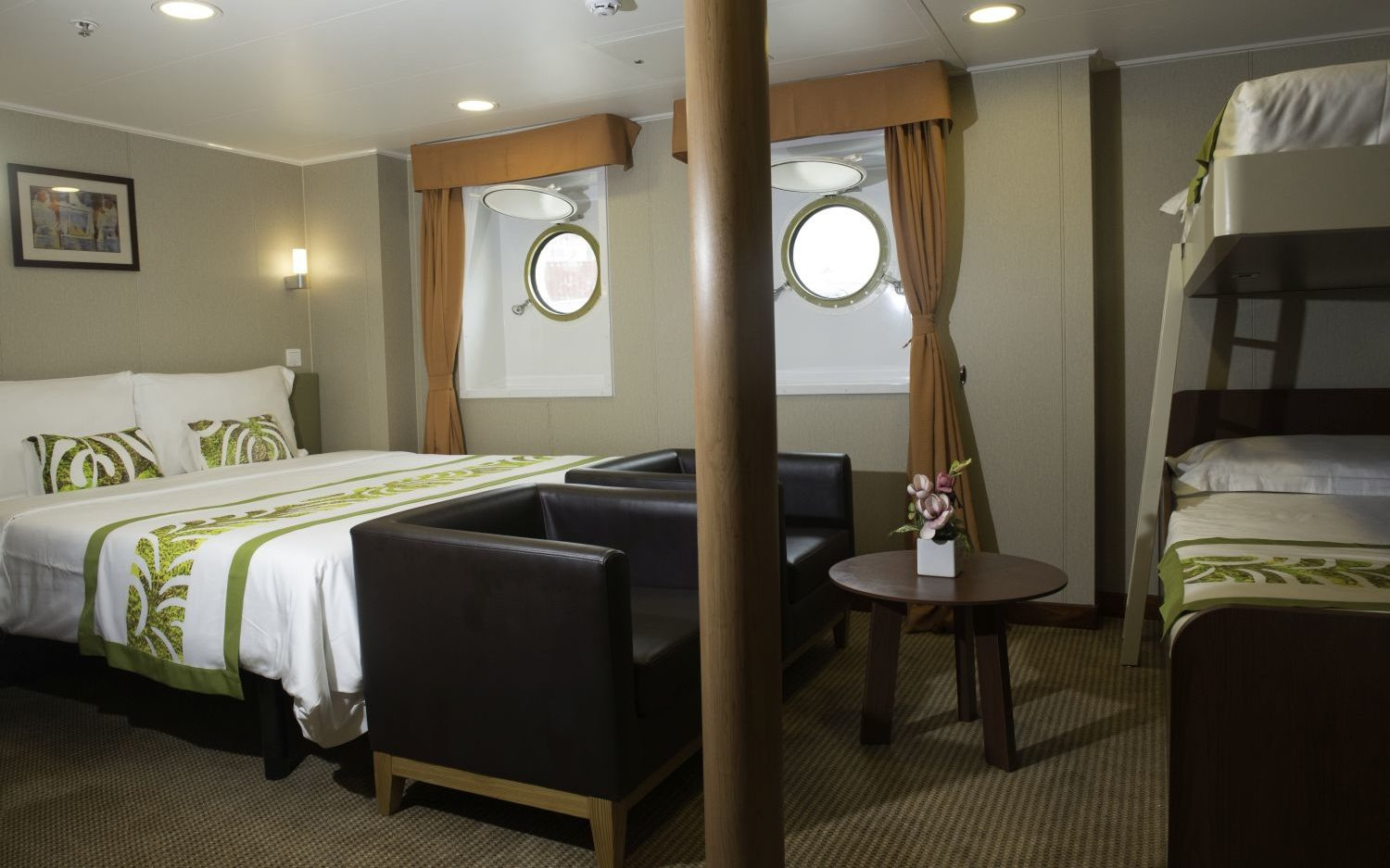 A Quadruple Stateroom, with a double bed, bunks, two armchairs and two portholes