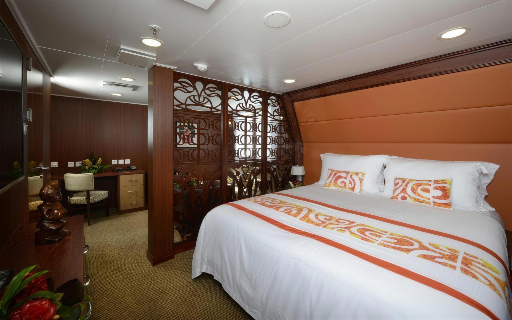 A Royal Suite, with a king bed and a carved screen before the sitting area