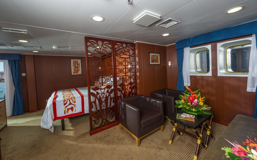 A Royal Suite with an obstructed view: armchairs, a carved screen and two windows
