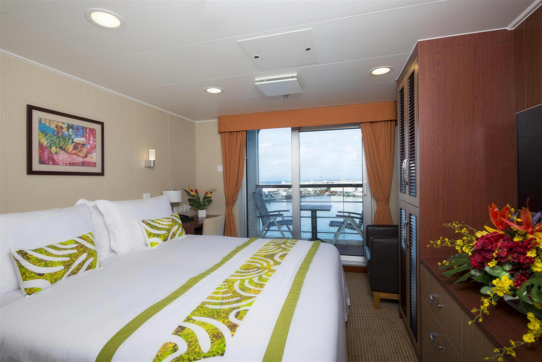A Superior Deluxe cabin, with a king bed and a glass door to the balcony