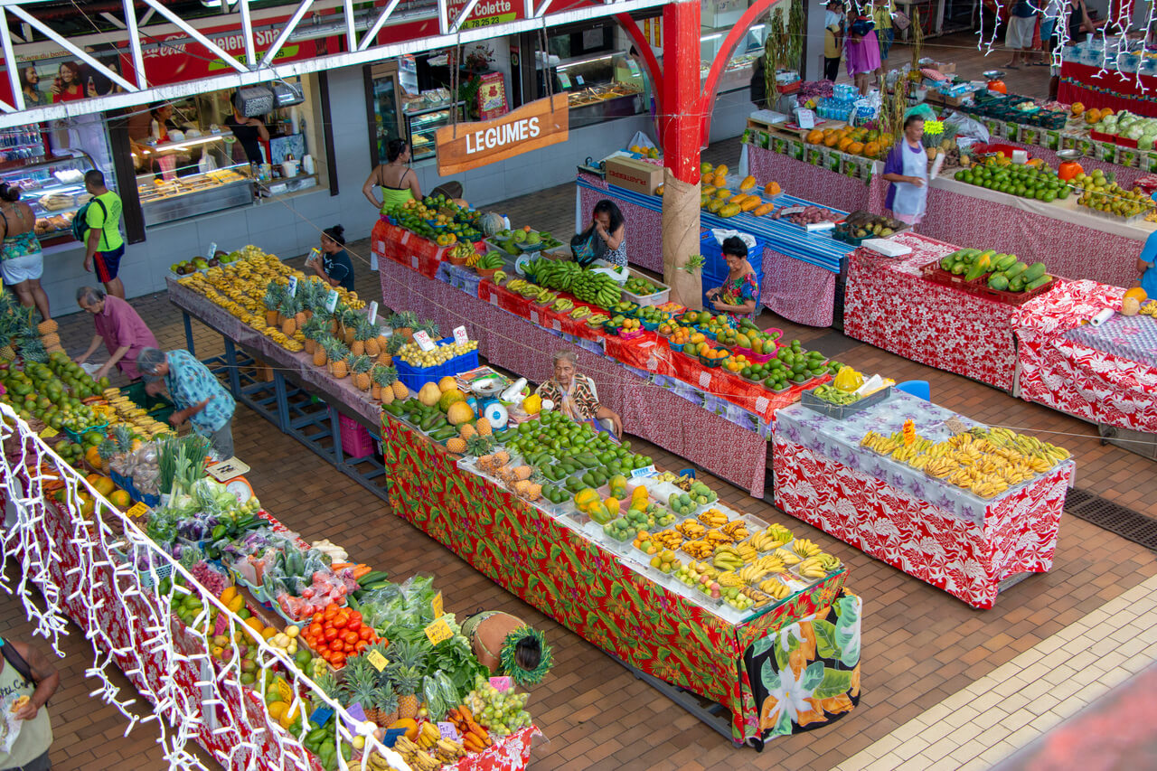 Fruit and vegetables piled on the stalls of the Papeete market, from above