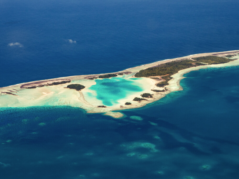 A turquoise pool inside the reef rim of Rangiroa, from the air