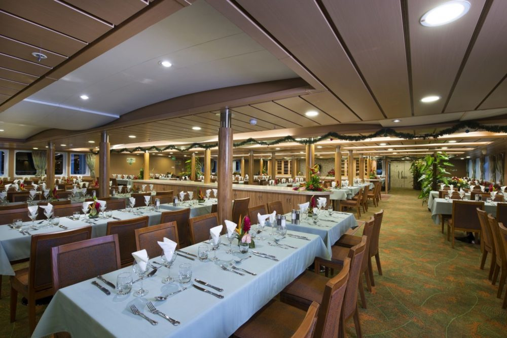 The restaurant, with long tables laid for dinner