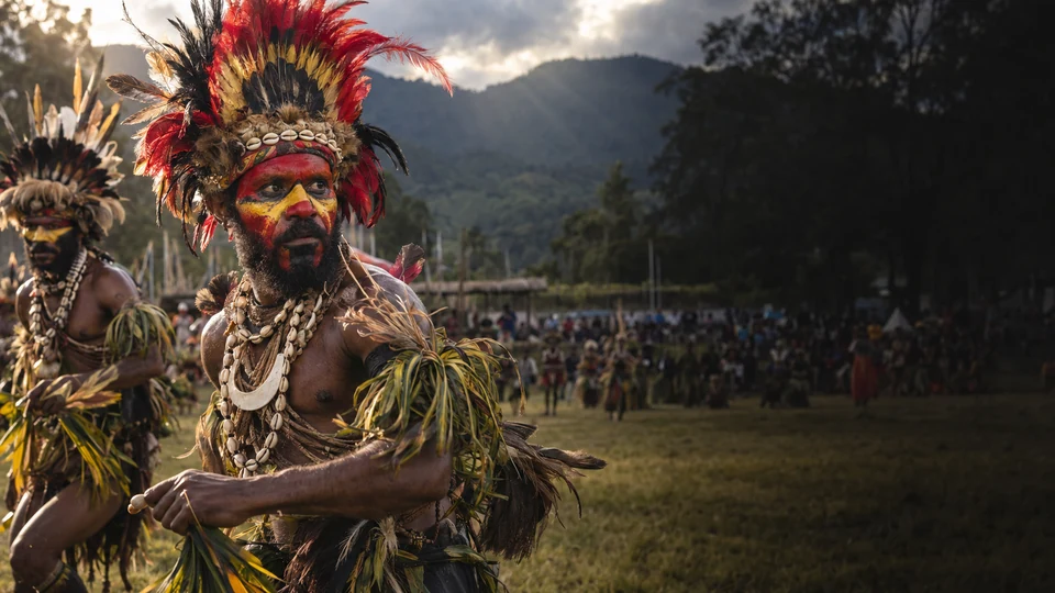Illustrative Goroka Show performer in feather headdress and ochre face paint