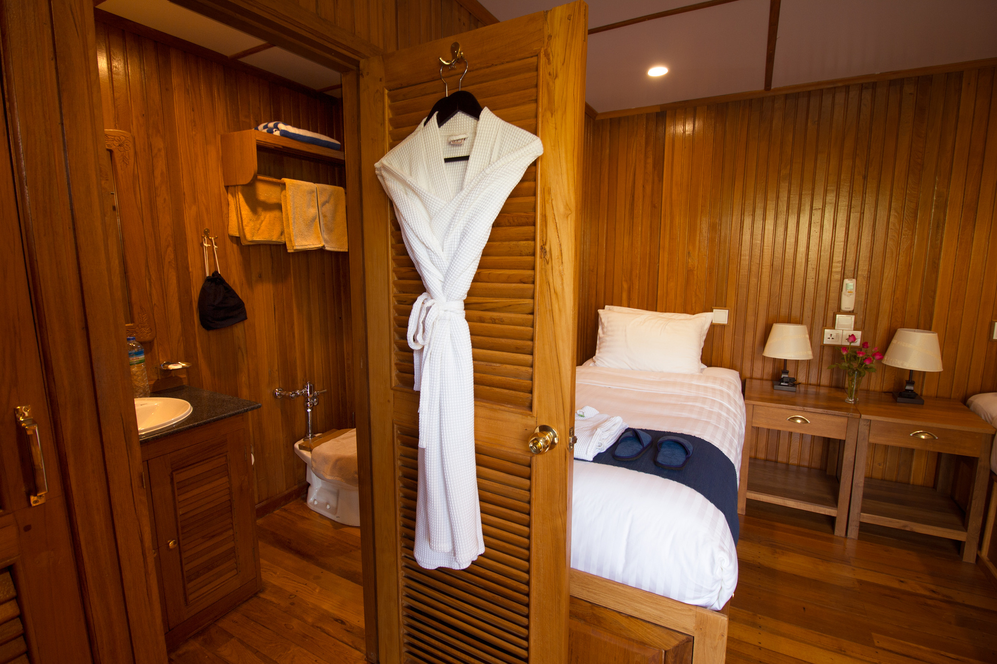 A kimono hanging by the bathroom door of a twin cabin