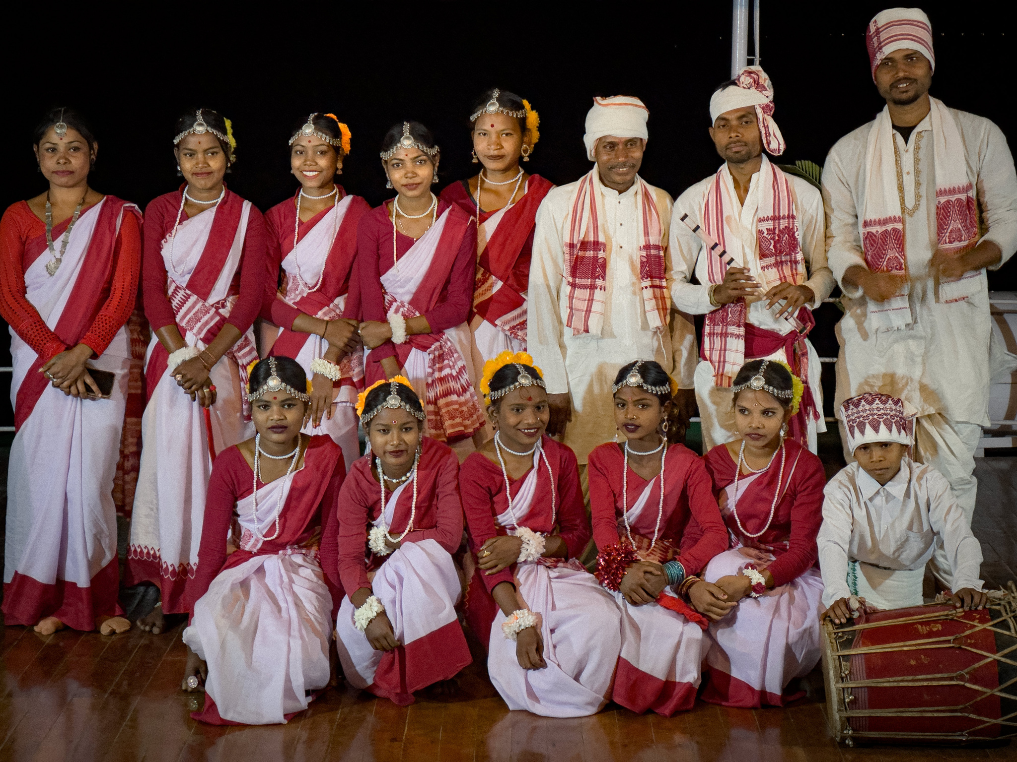 A dance troupe and its drummers in red and white
