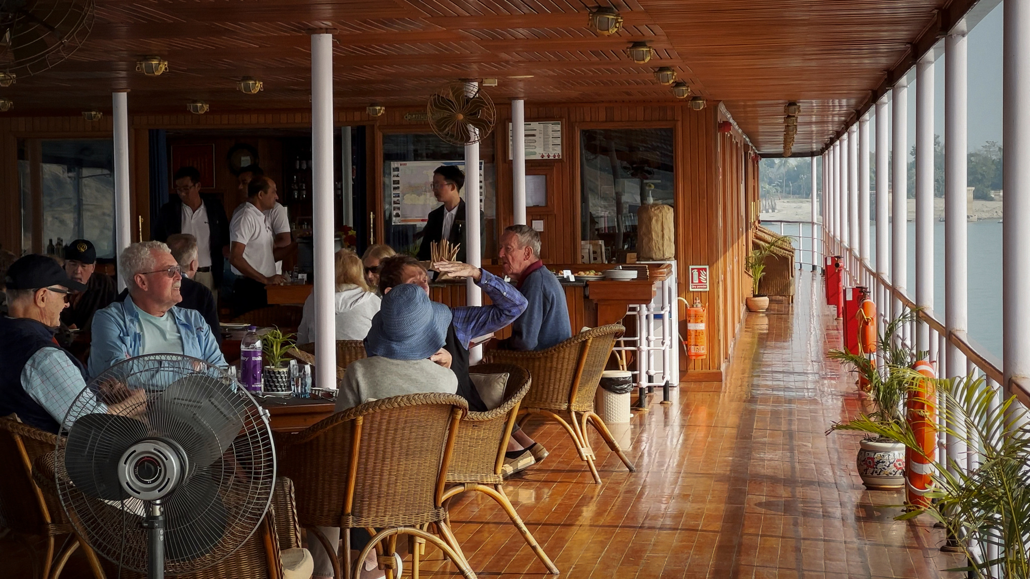 Guests at lunch at the tables along the deck