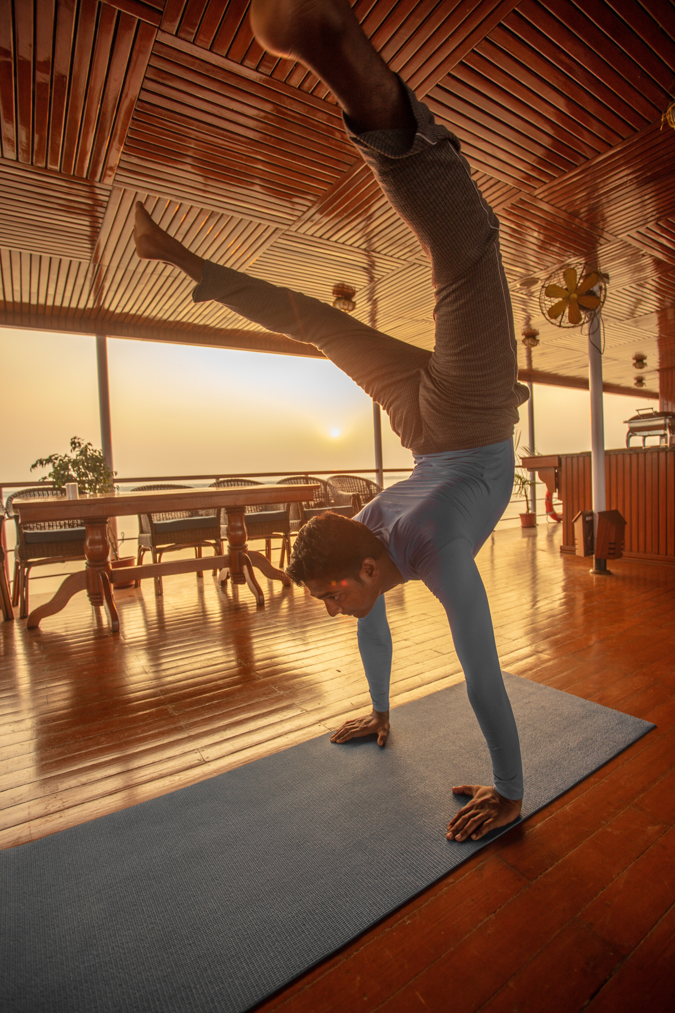 A guest doing yoga on deck in the morning light