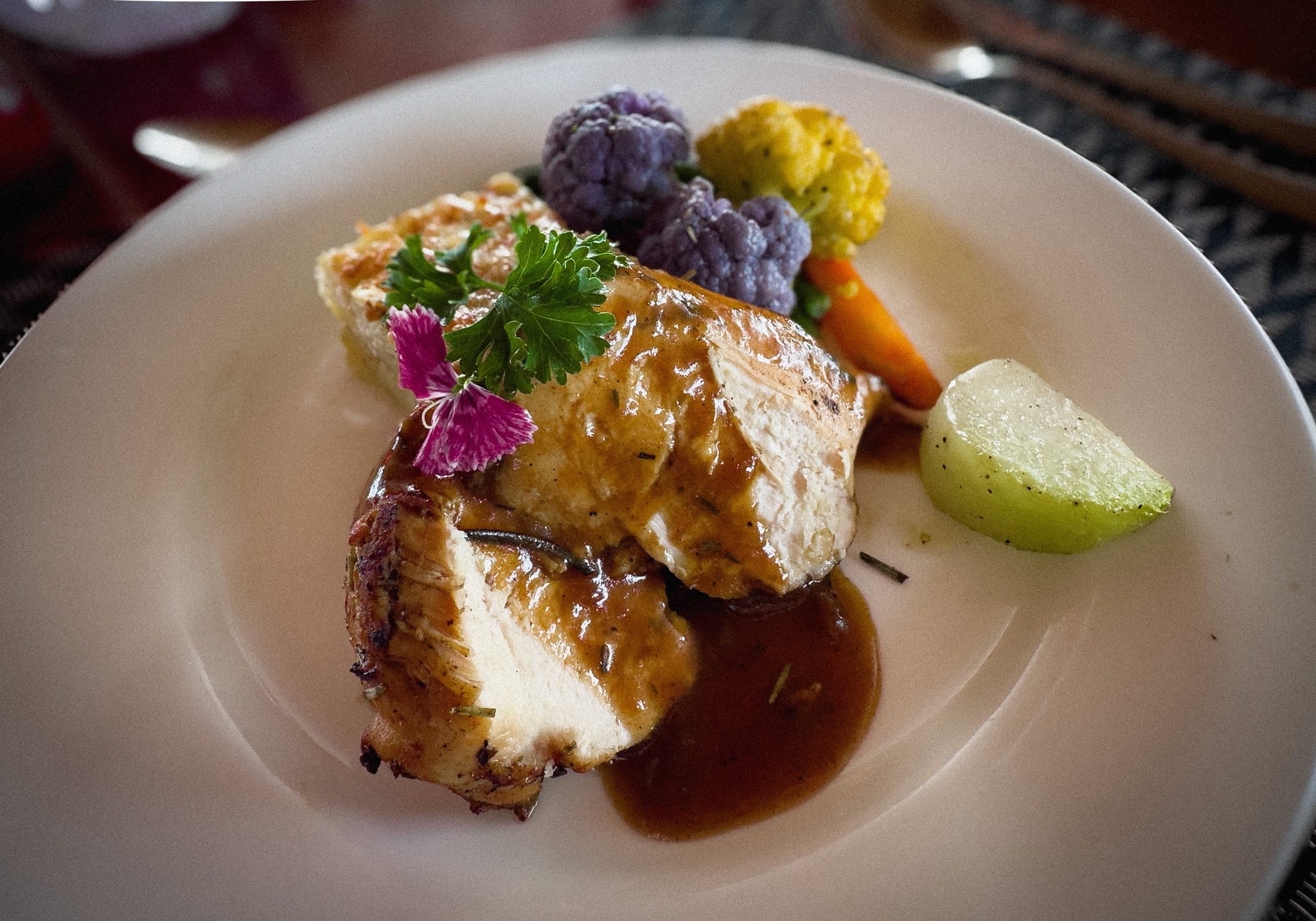 A plated dinner course with a wedge of lime