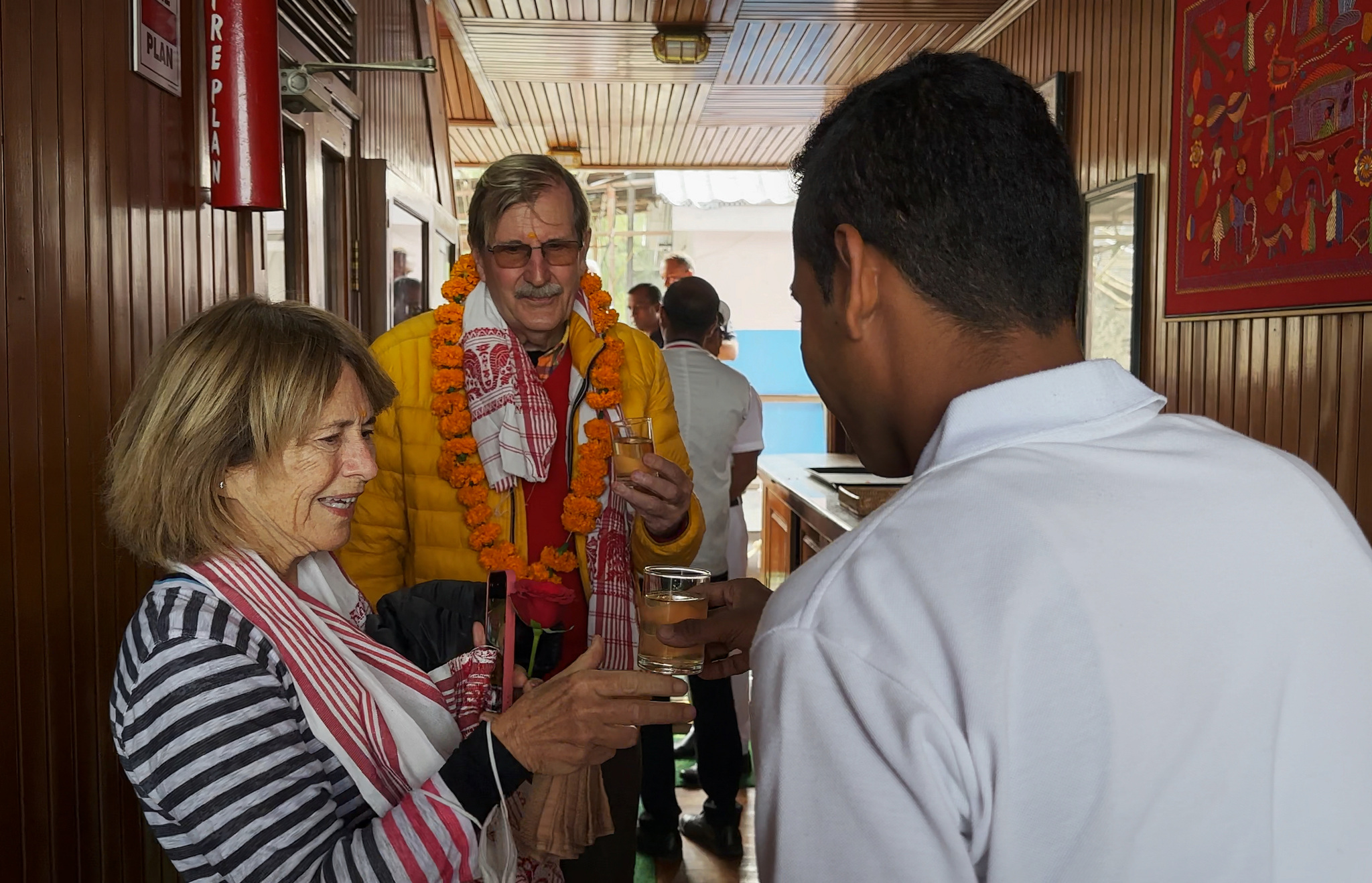 Guests welcomed aboard with a gamosa scarf and a garland