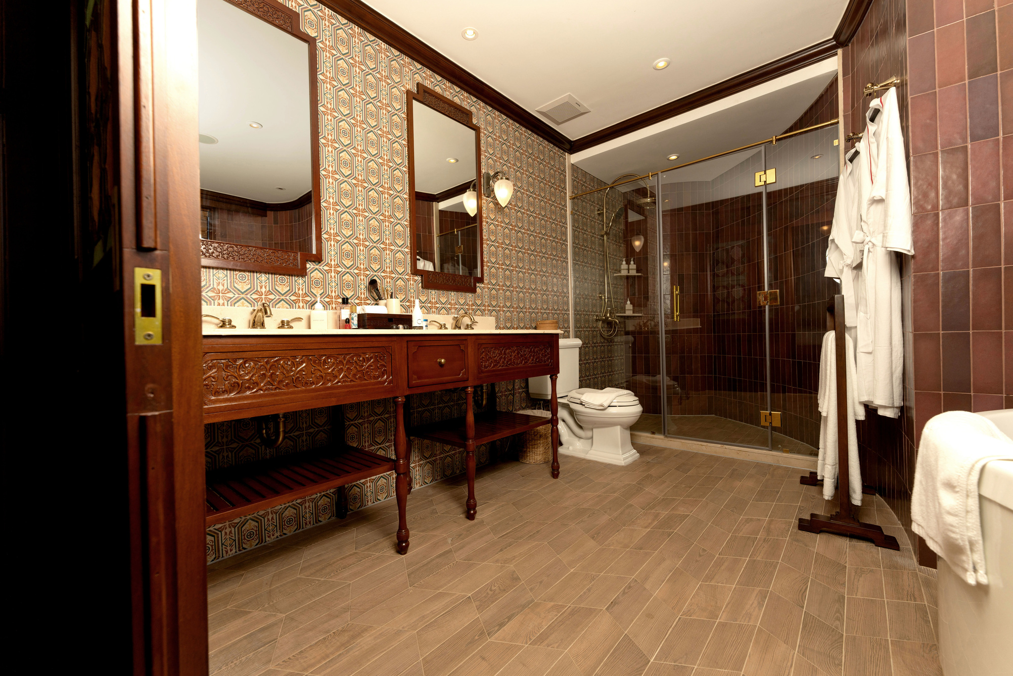 A bathroom with twin basins and a walk-in shower