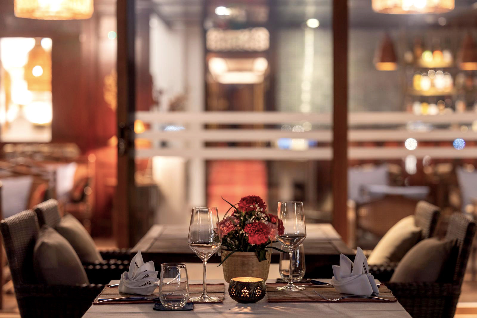 A table set for dinner, with roses and candlelight