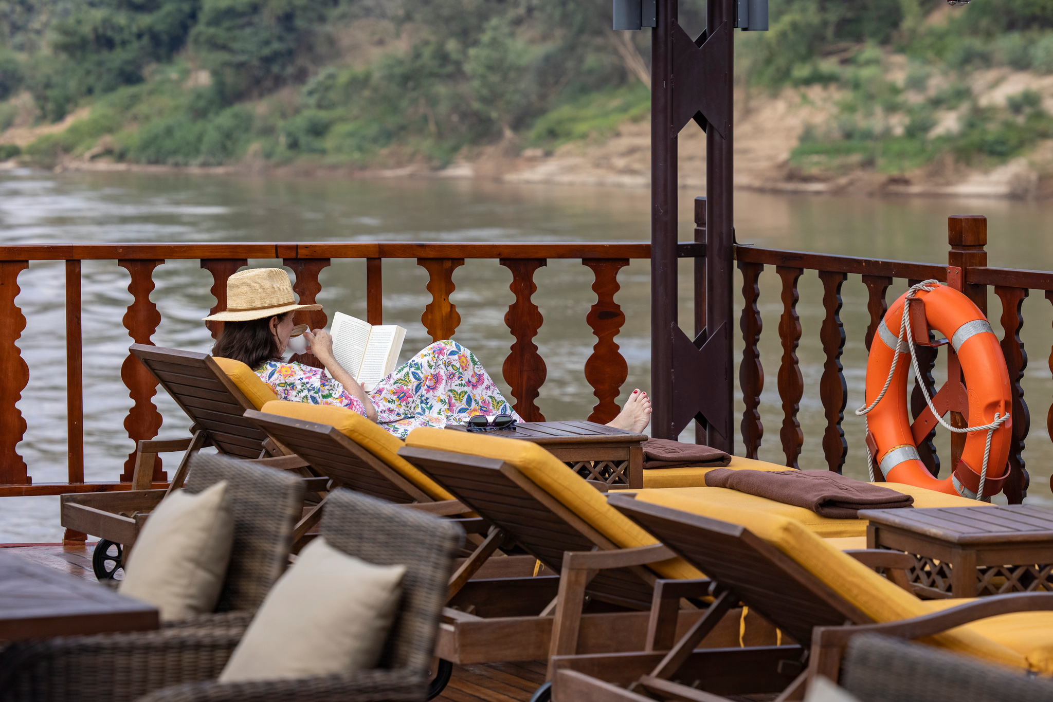 Reading on a sun lounger as the river slides past