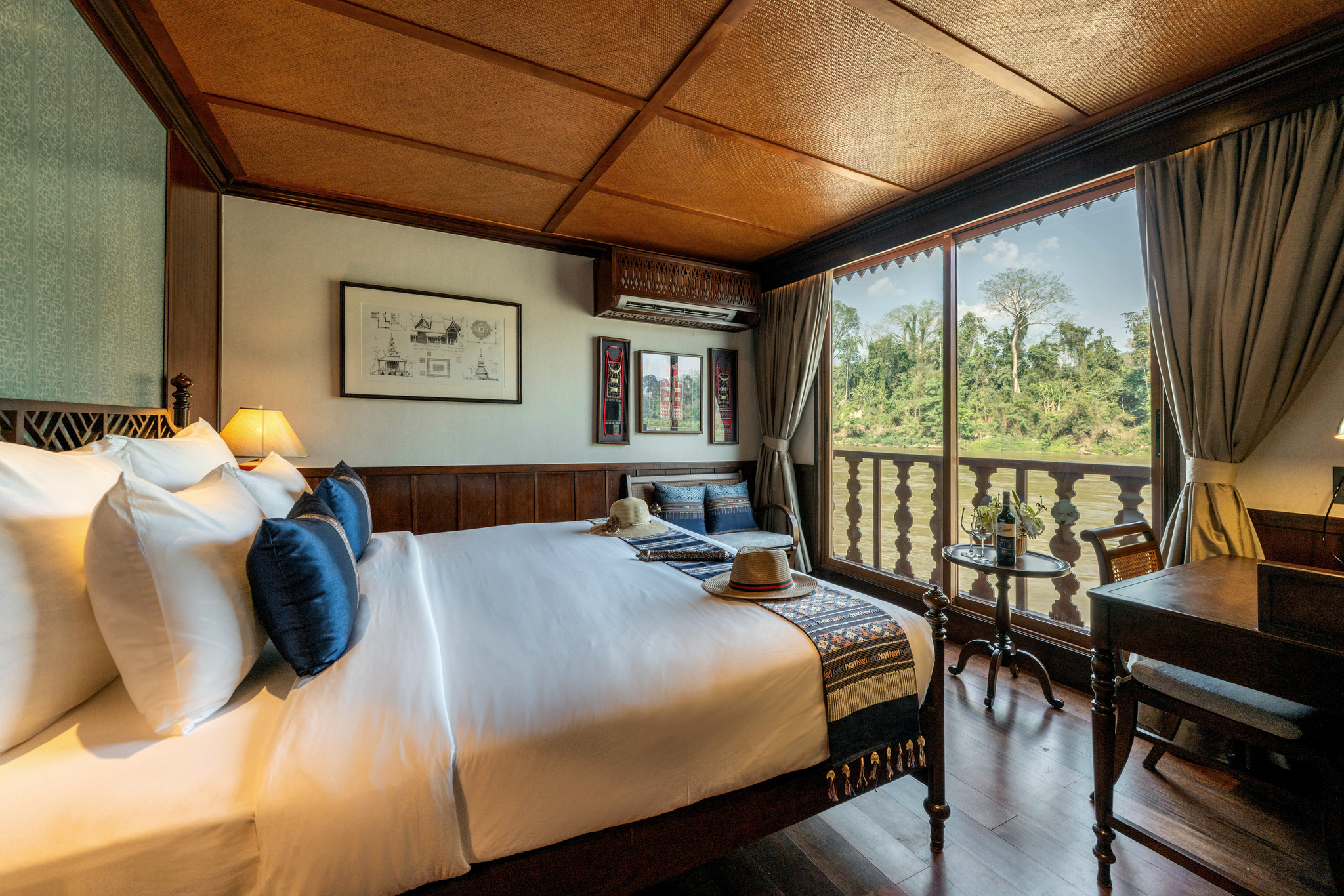 A stateroom looking out on the forested bank
