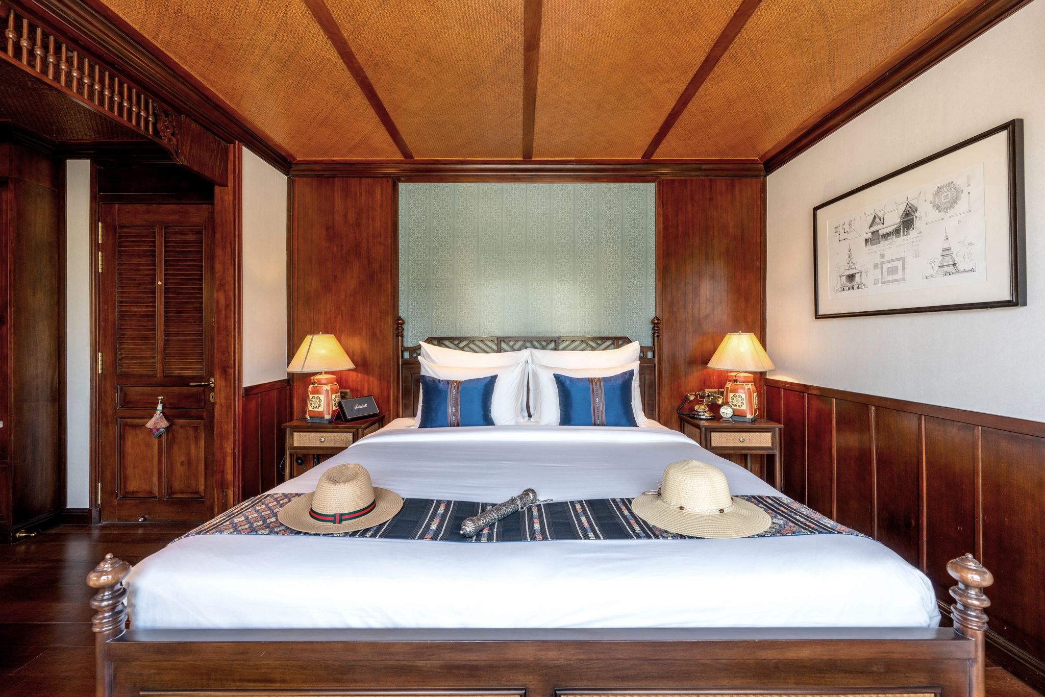 A stateroom bed laid with hats for the day ashore