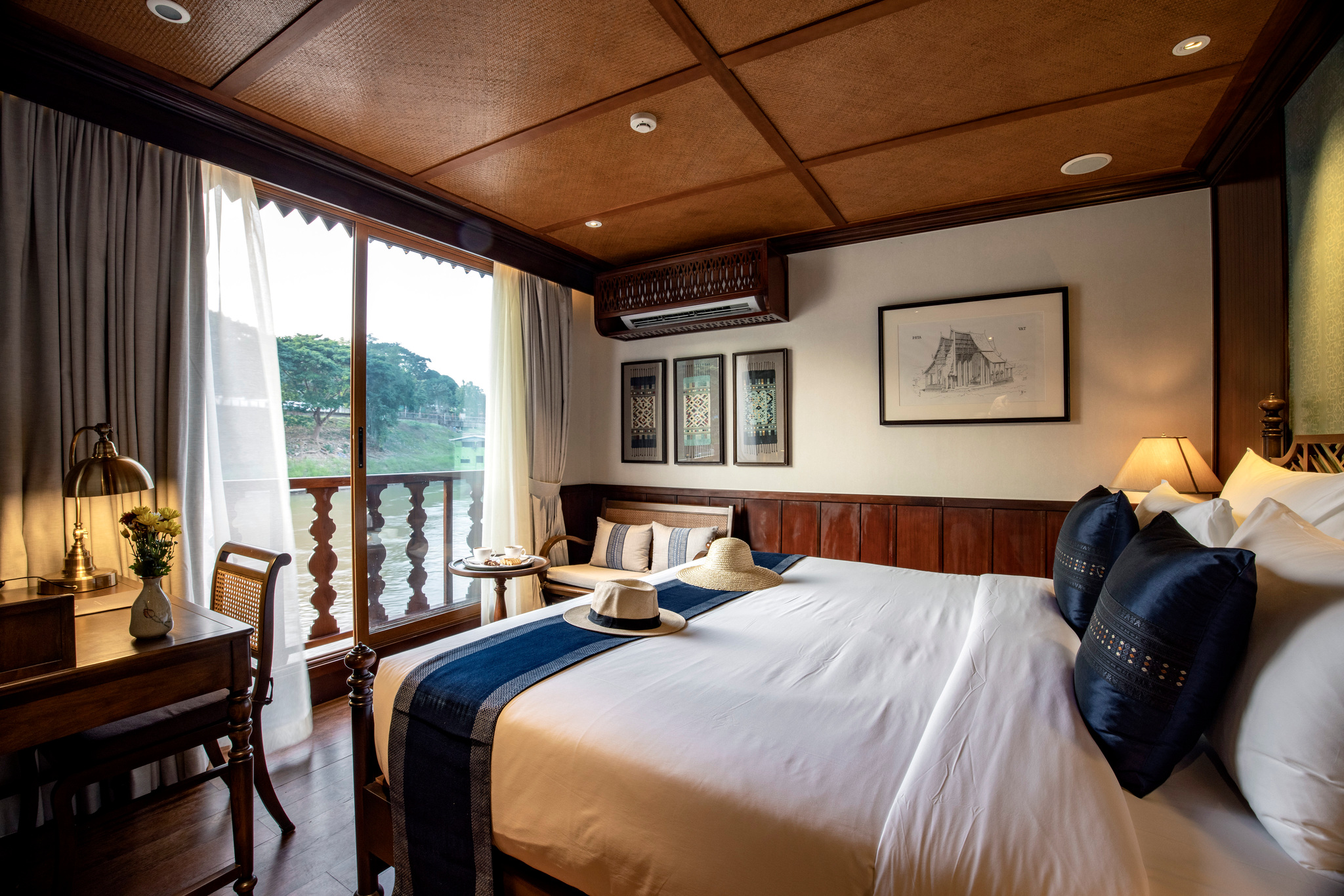 A stateroom with floor-to-ceiling windows on the river