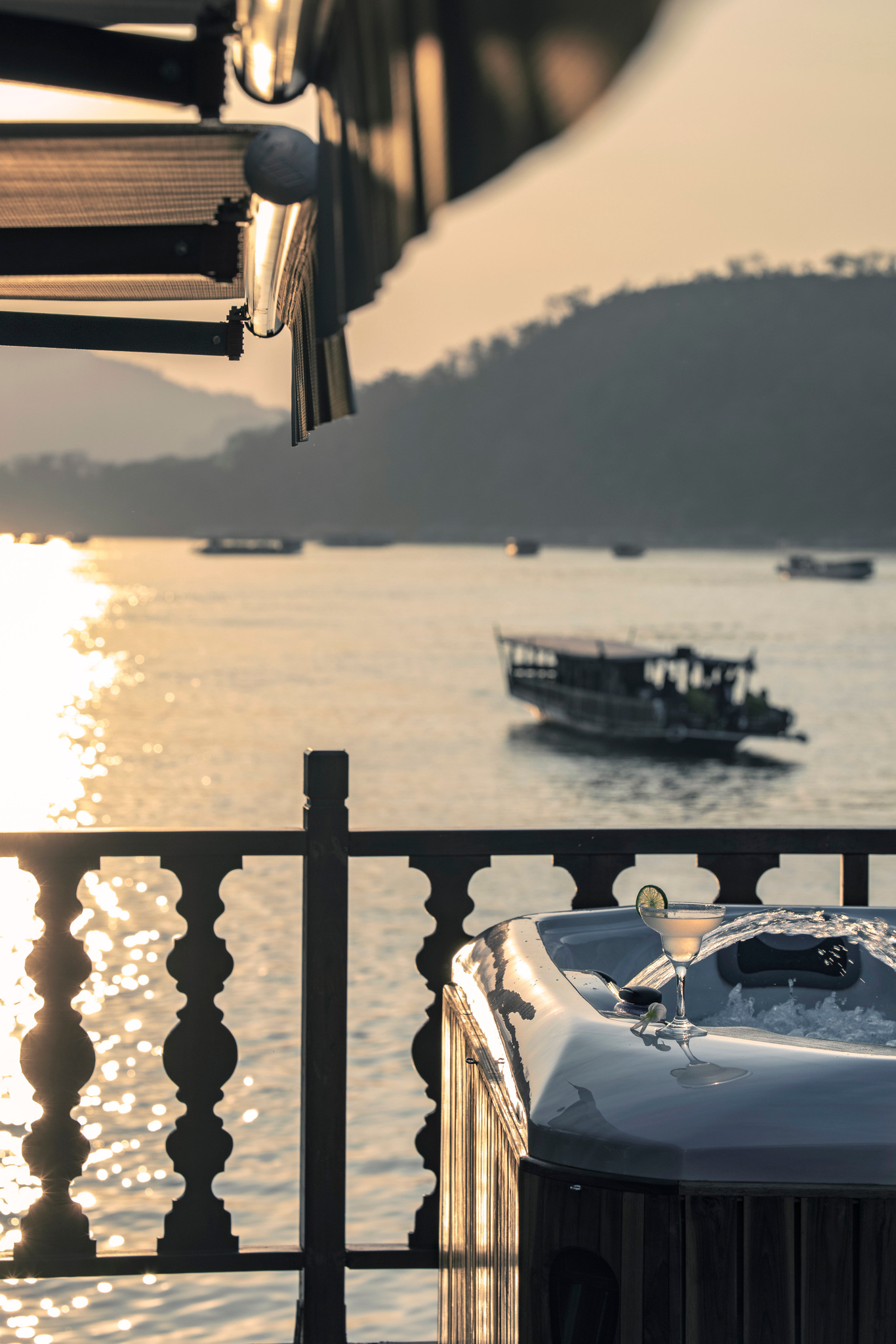 A river boat passing the stern at sunset
