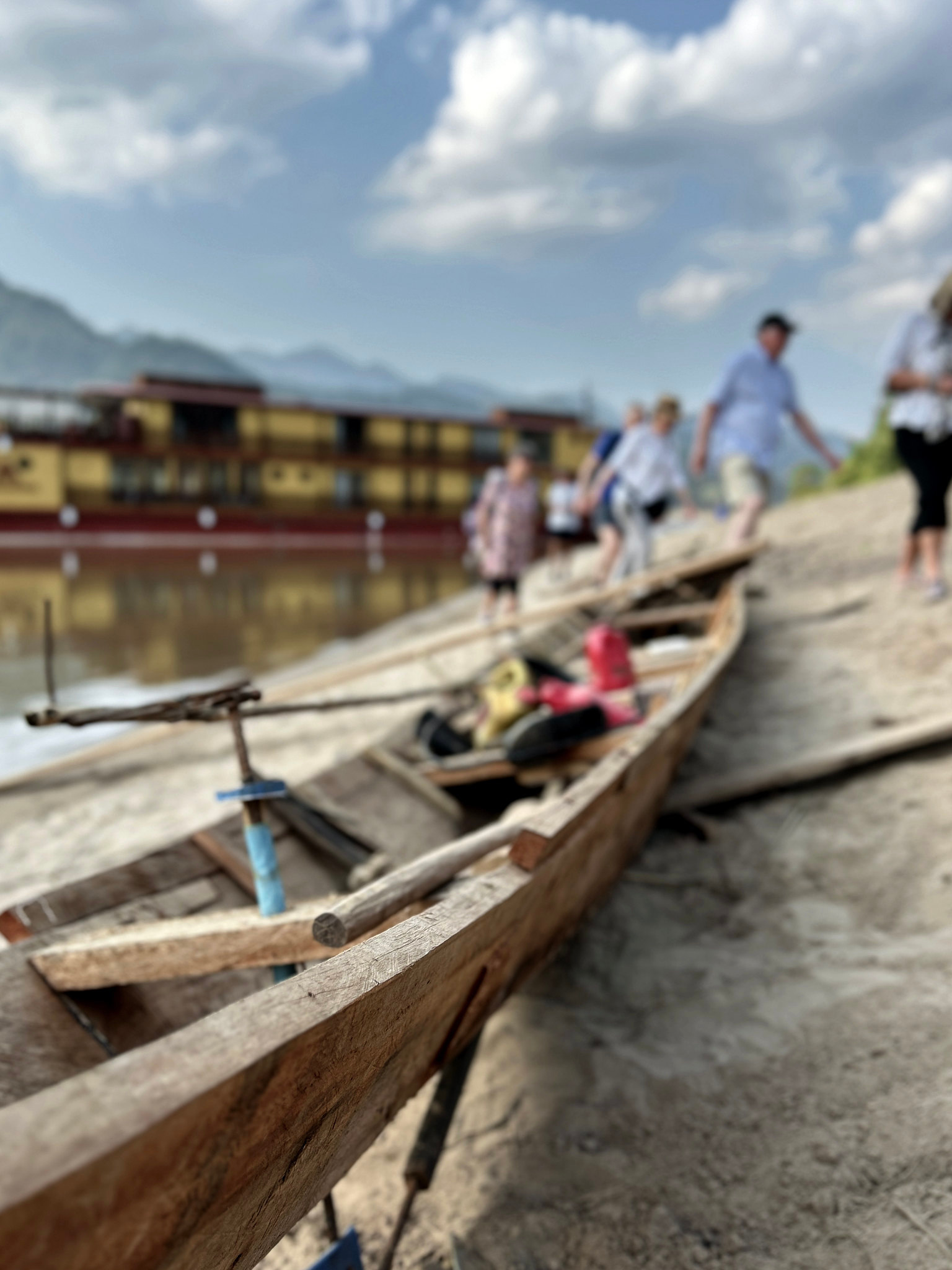 A wooden longtail boat drawn up on a beach