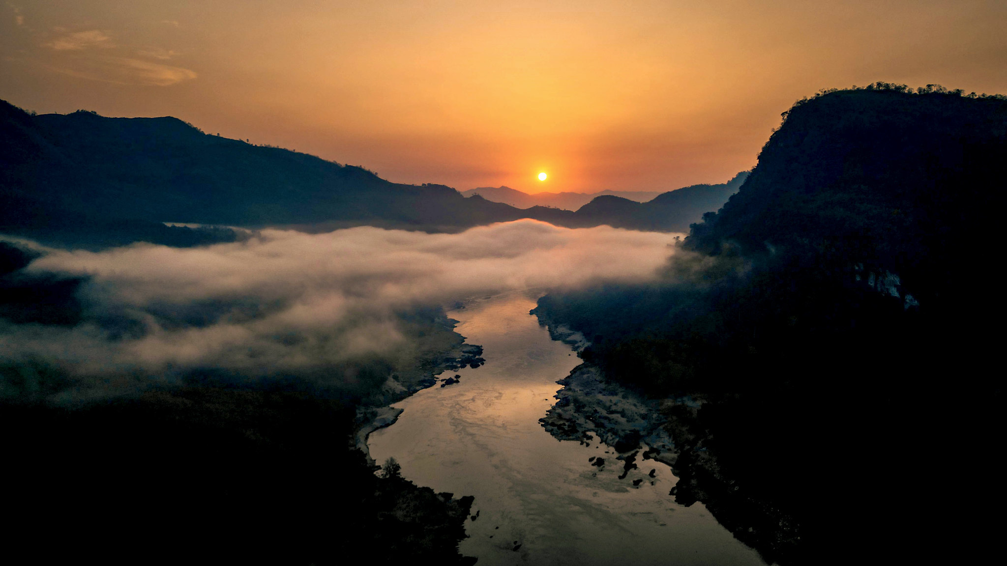 Sunrise over mist in a Mekong valley