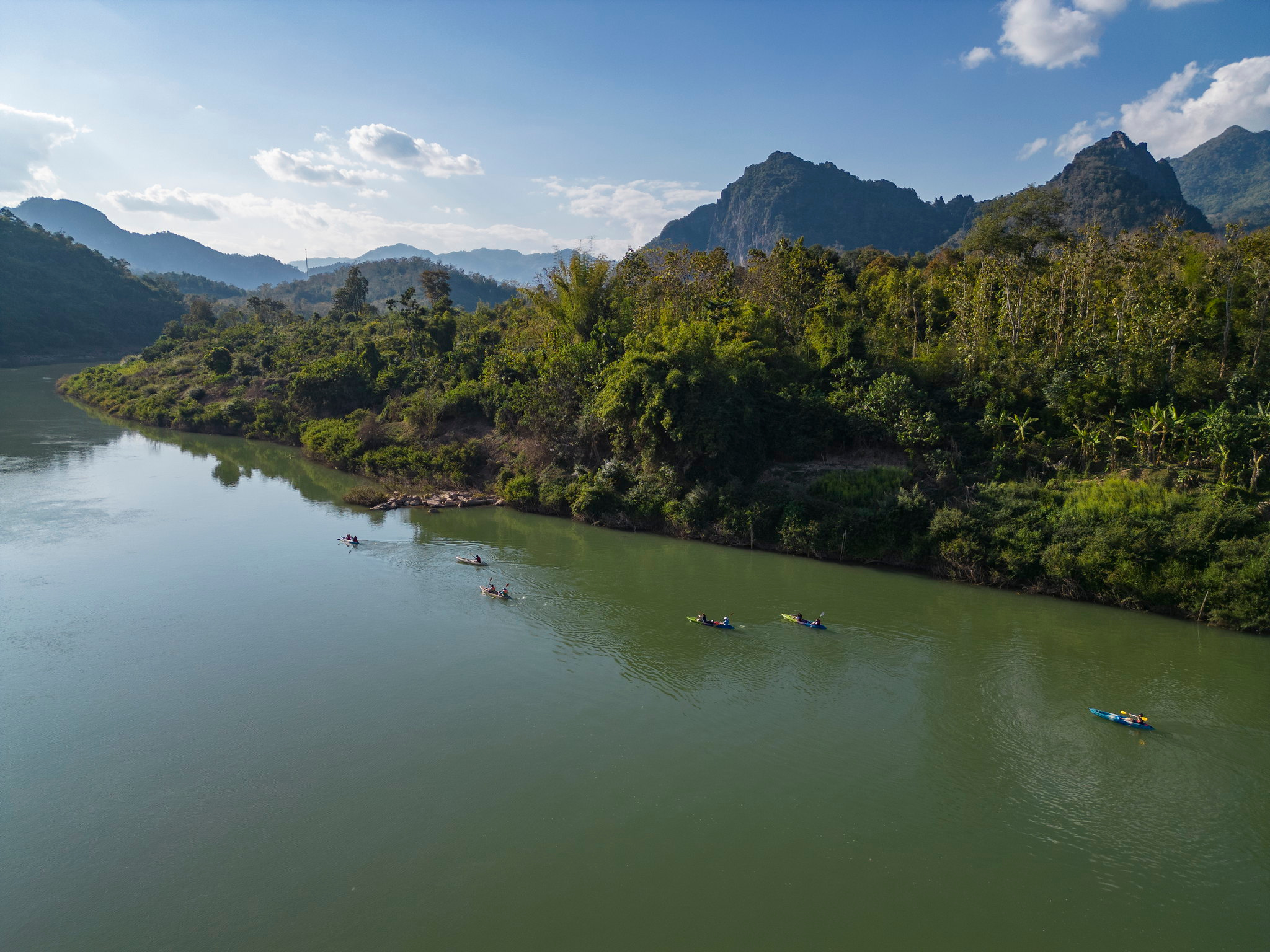 Kayaks on the Nam Ou below limestone peaks