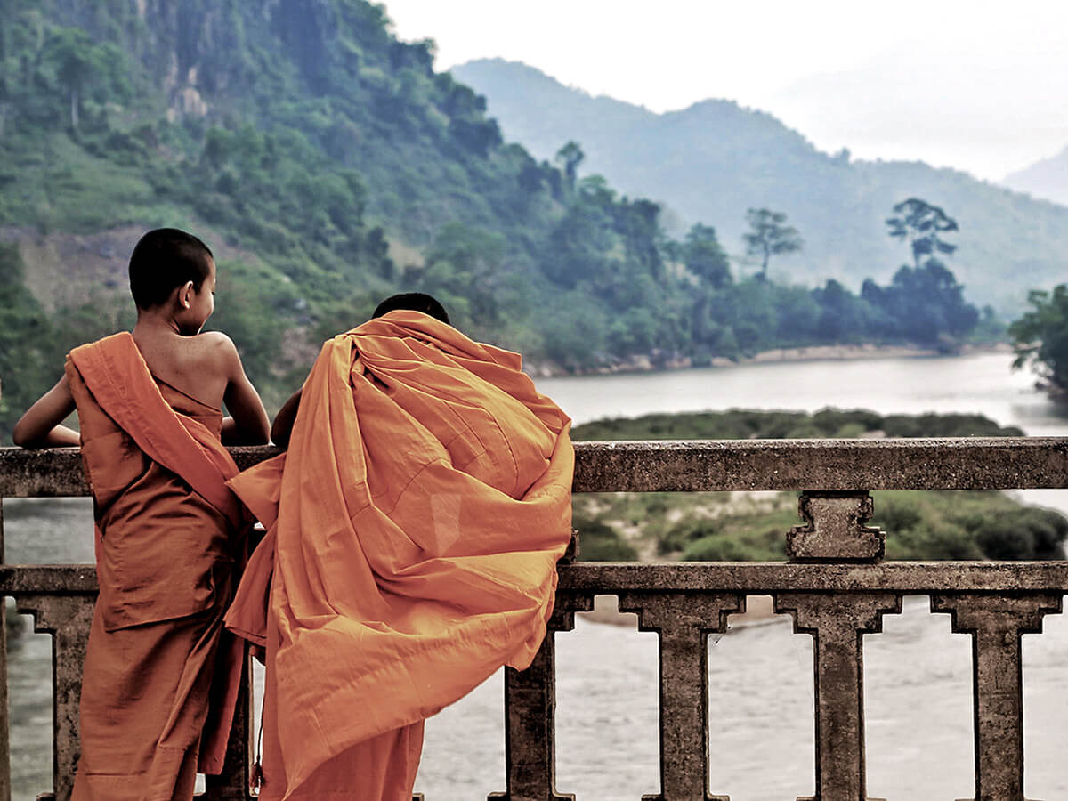 Two novice monks looking out over the Mekong
