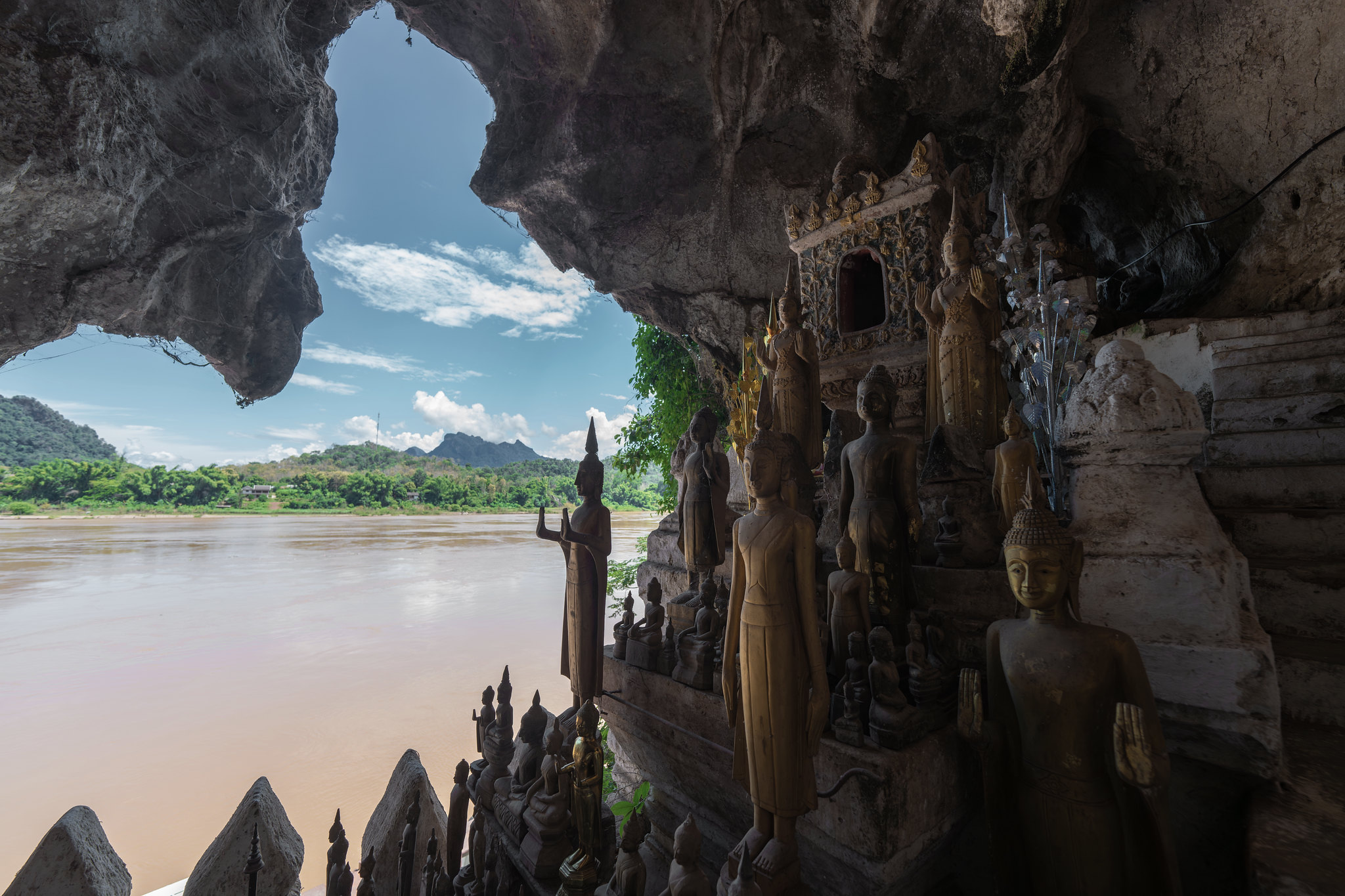 Buddha images in the Pak Ou caves, looking out on the Mekong