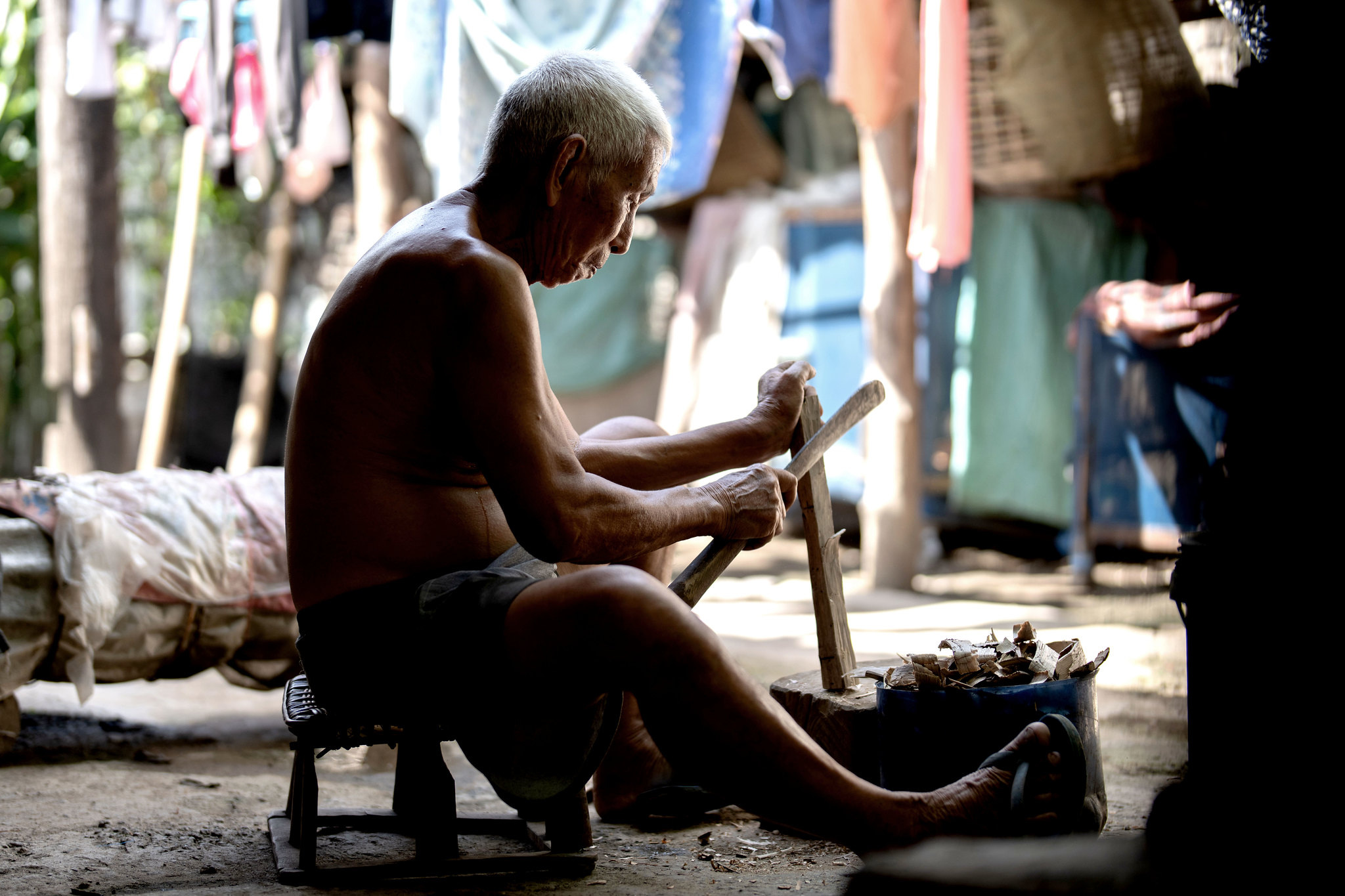 A craftsman at work beneath his house