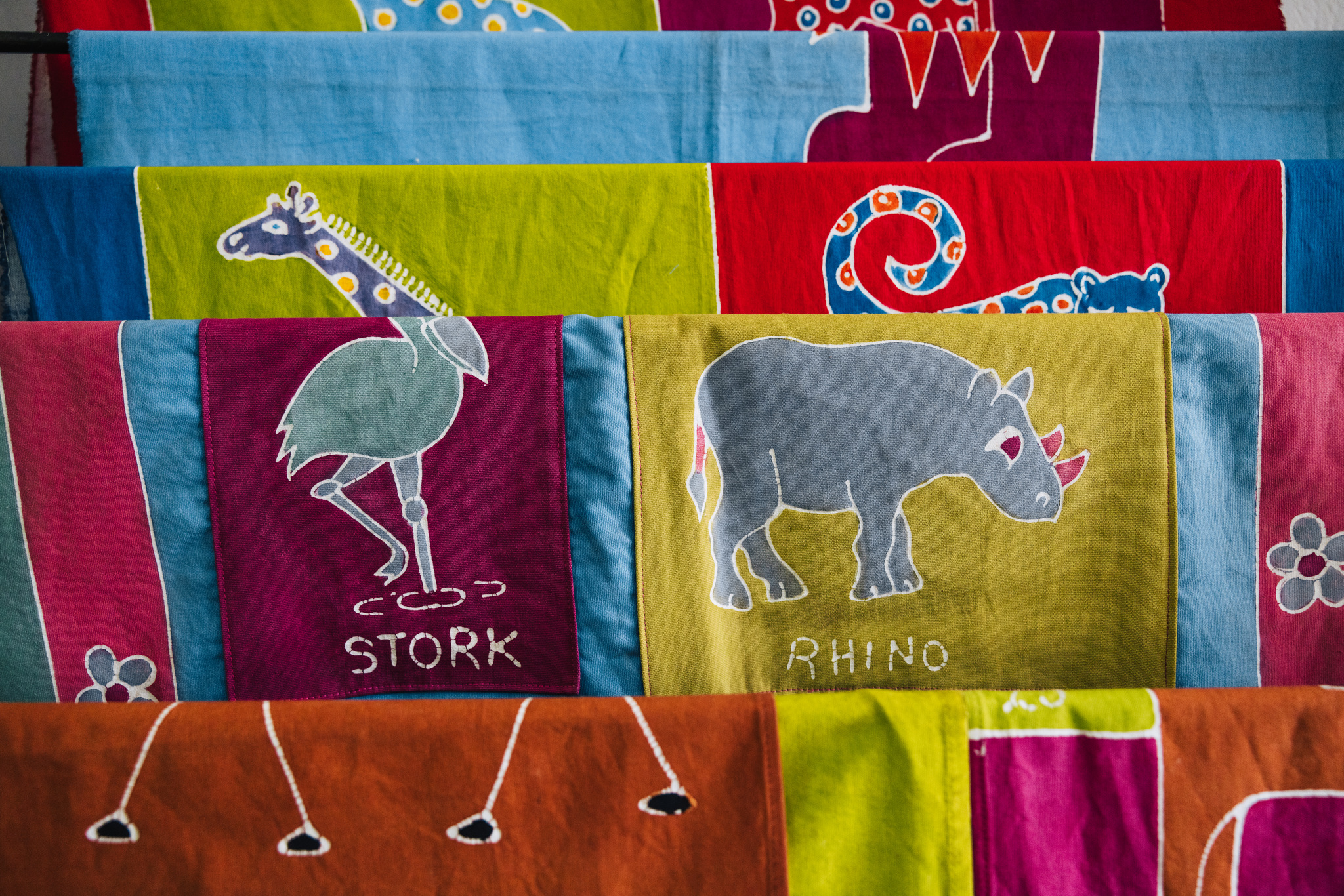 Hand-painted batik cloths of a stork and a rhino, for sale in Blantyre