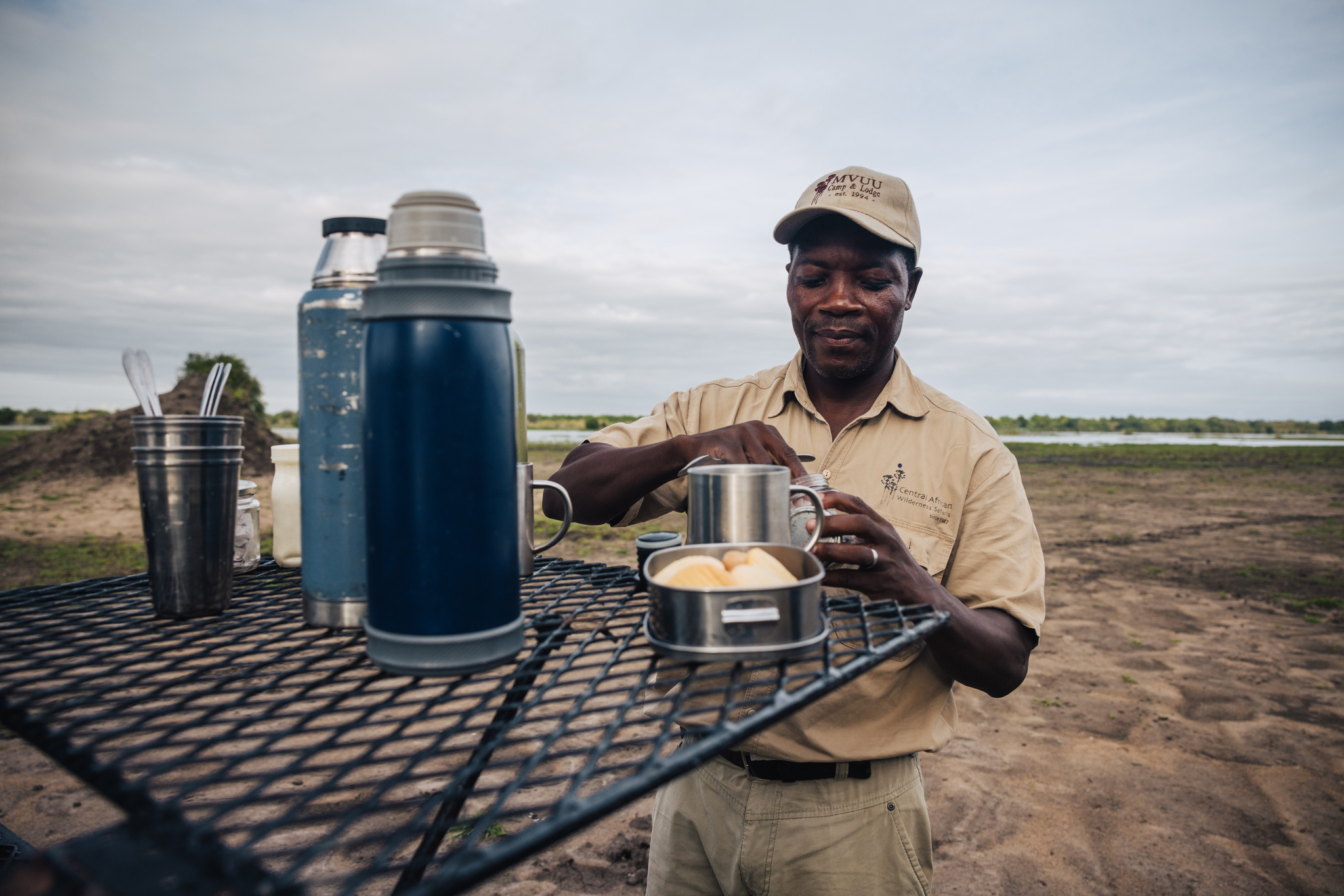 A guide sets out coffee at a stop during a game drive