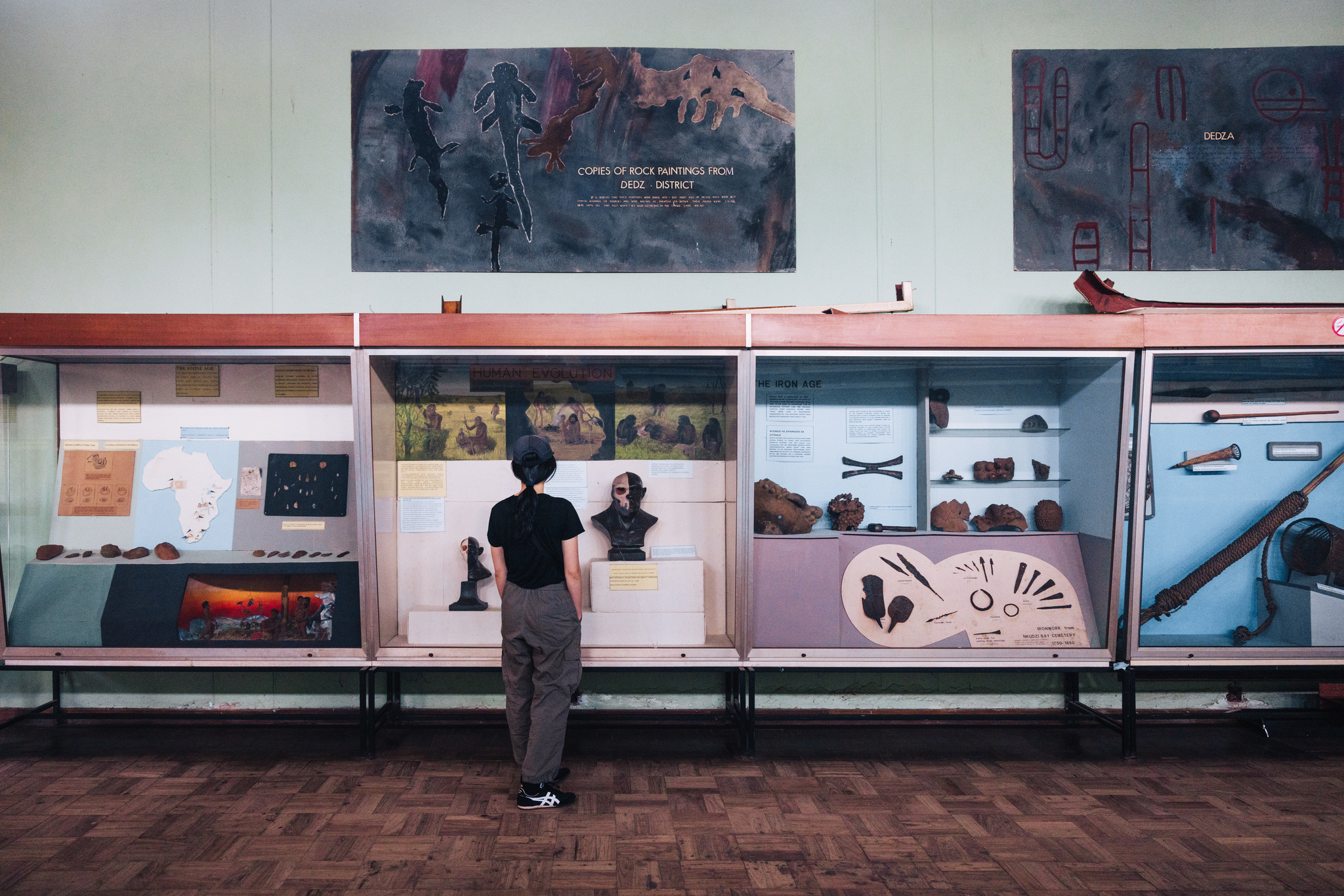 A visitor at the displays in the Museum of Malawi, below copies of rock paintings from Dedza District