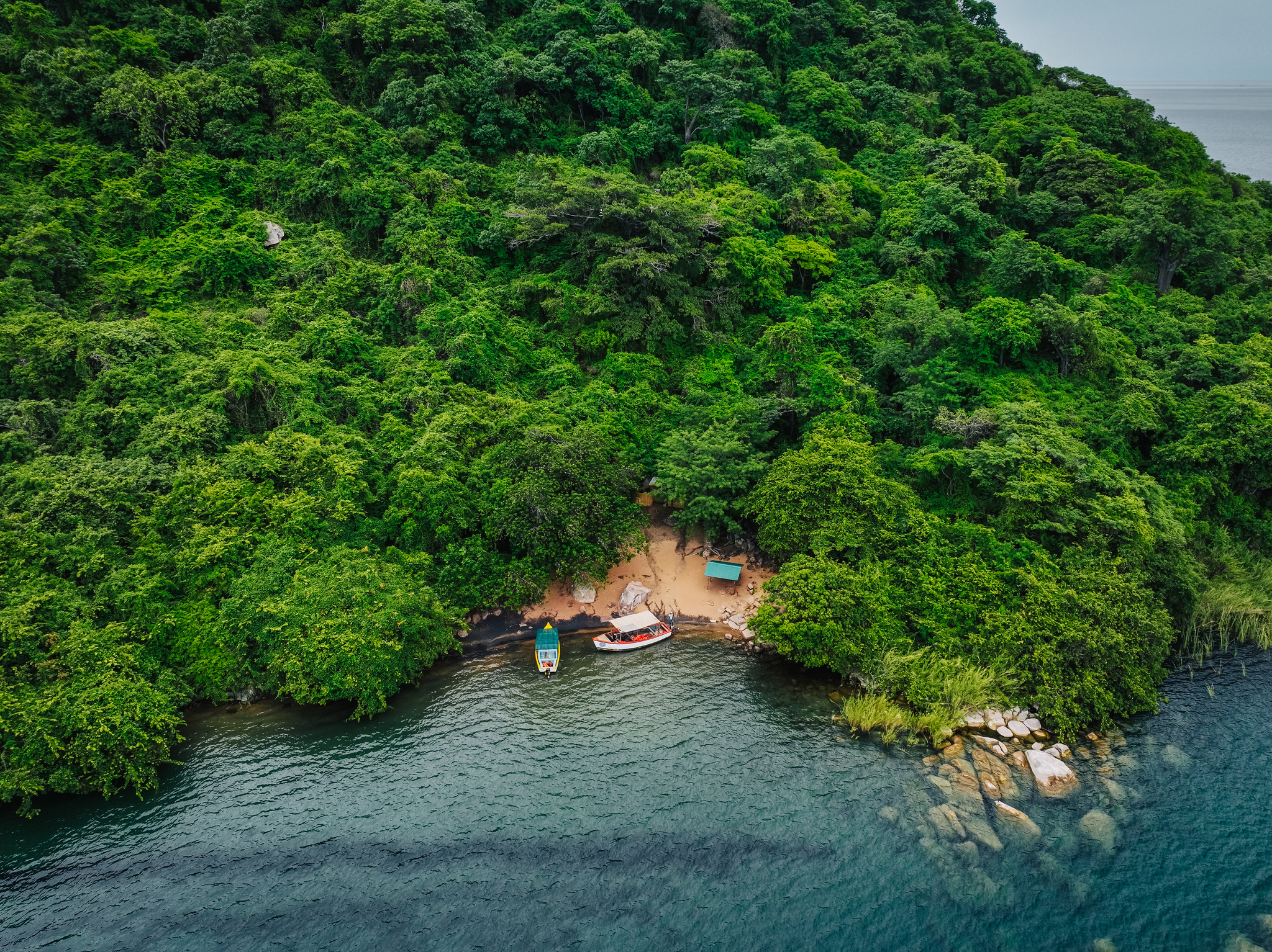 Boats drawn up in a small cove on an island off Cape Maclear, from the air