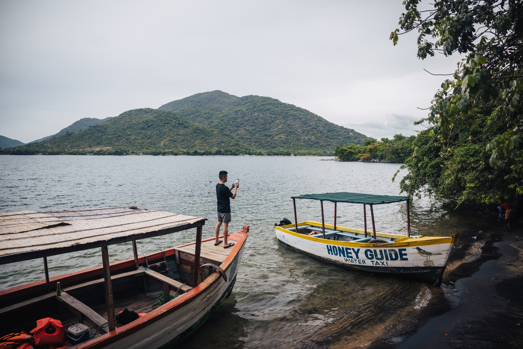 Boats at a landing below the trees in Lake Malawi National Park