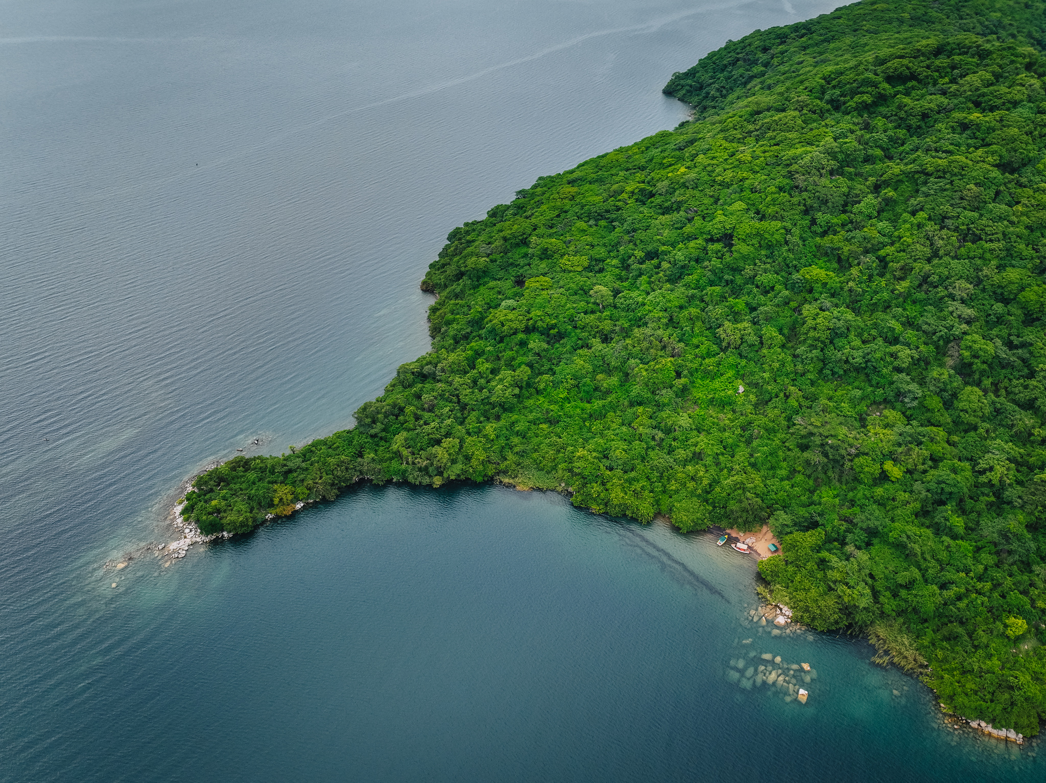 An island off Cape Maclear in Lake Malawi National Park, its forest running down to clear water