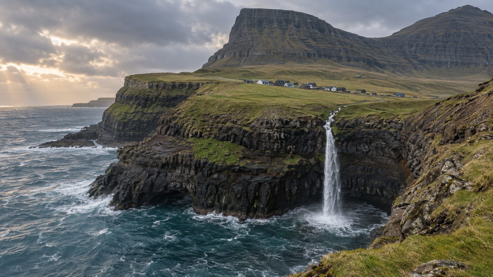 Coastal waterfall and village landscape on Vagar in the Faroe Islands