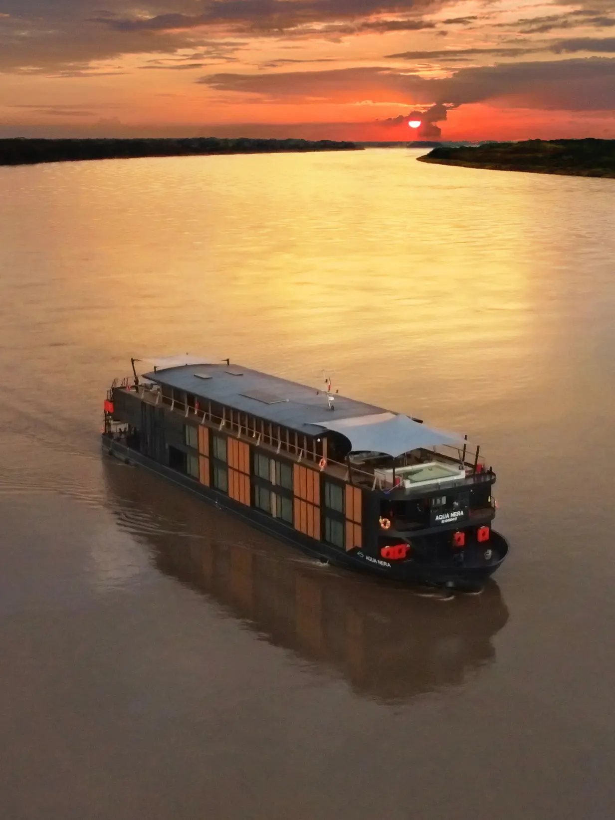 Aqua Nera on a wide stretch of the river at sunset, seen from above