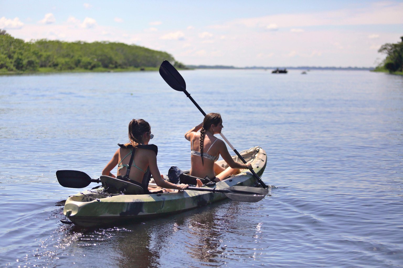 Two guests in a kayak on the open river